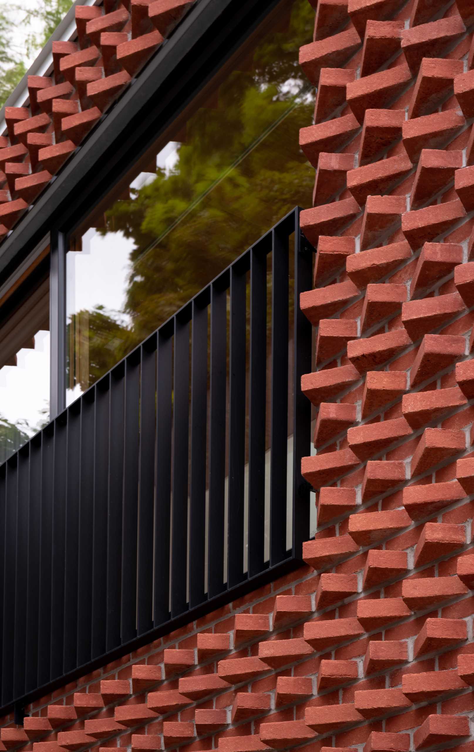 A modern laneway house with a rotated red brick facade.