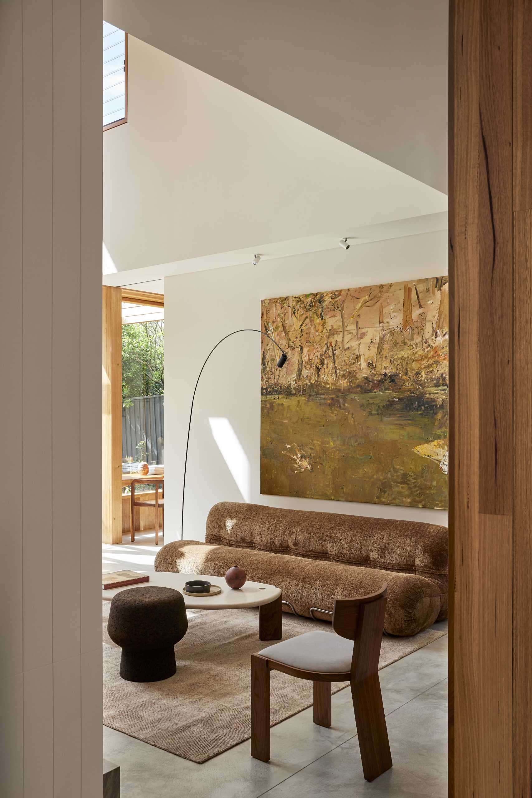 A double-height living room in a contemporary extension with polished concrete floors.
