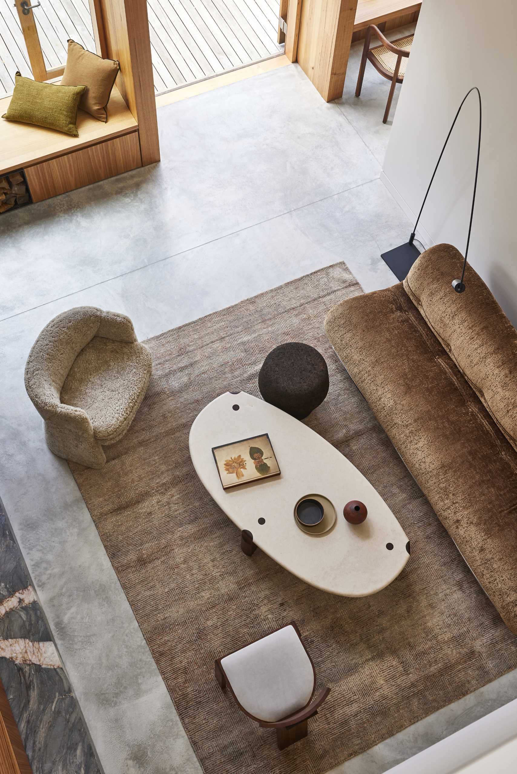 A double-height living room in a contemporary extension with polished concrete floors.