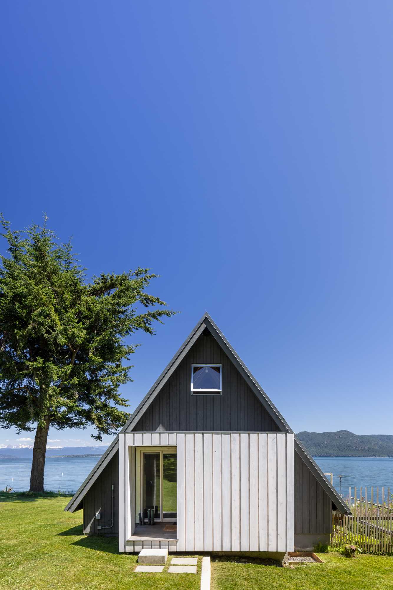 A waterfront A-frame home that's been renovated with contemporary finishes.