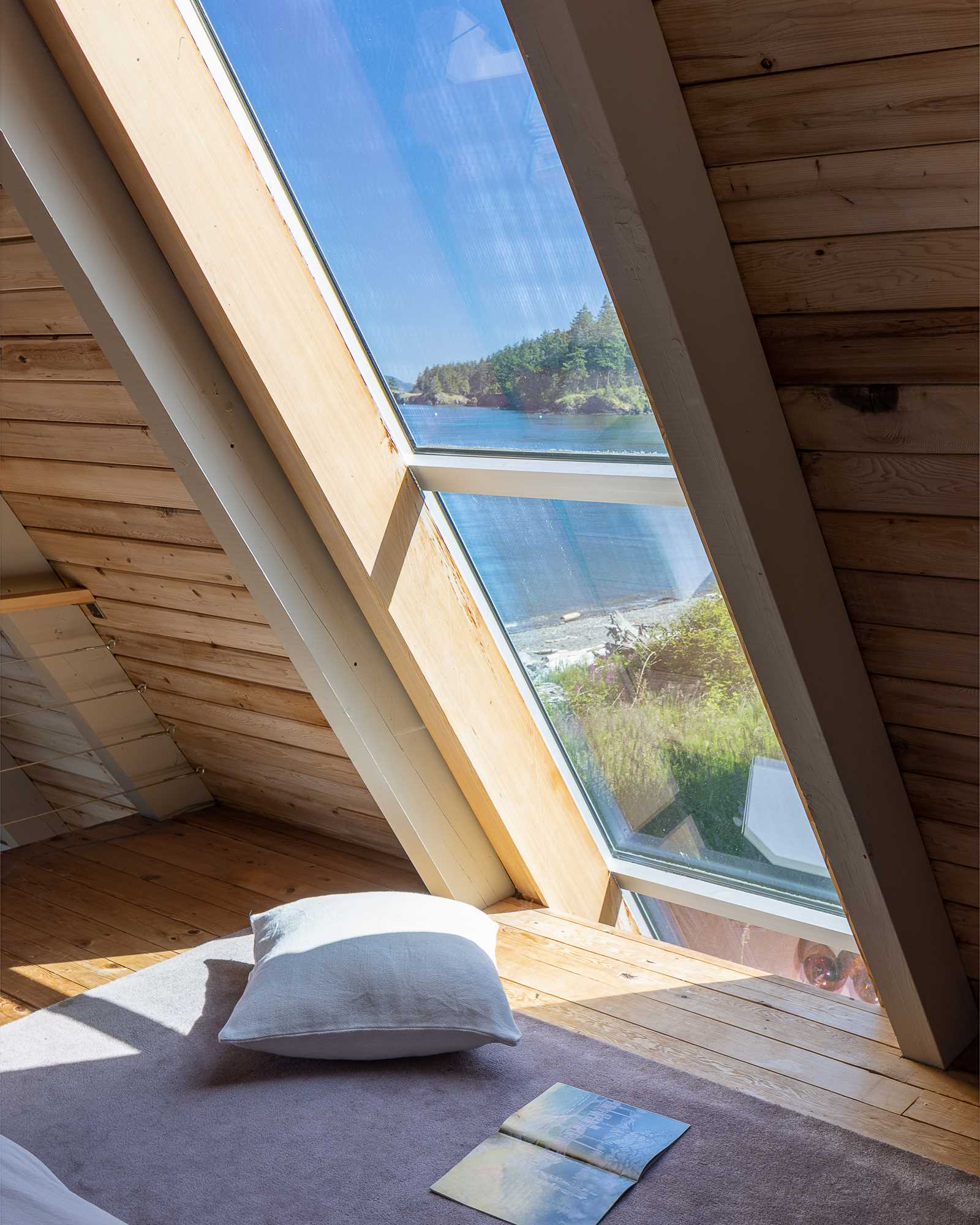 This bedroom in an A-Frame home includes a freestanding bed as well as built-in beds.