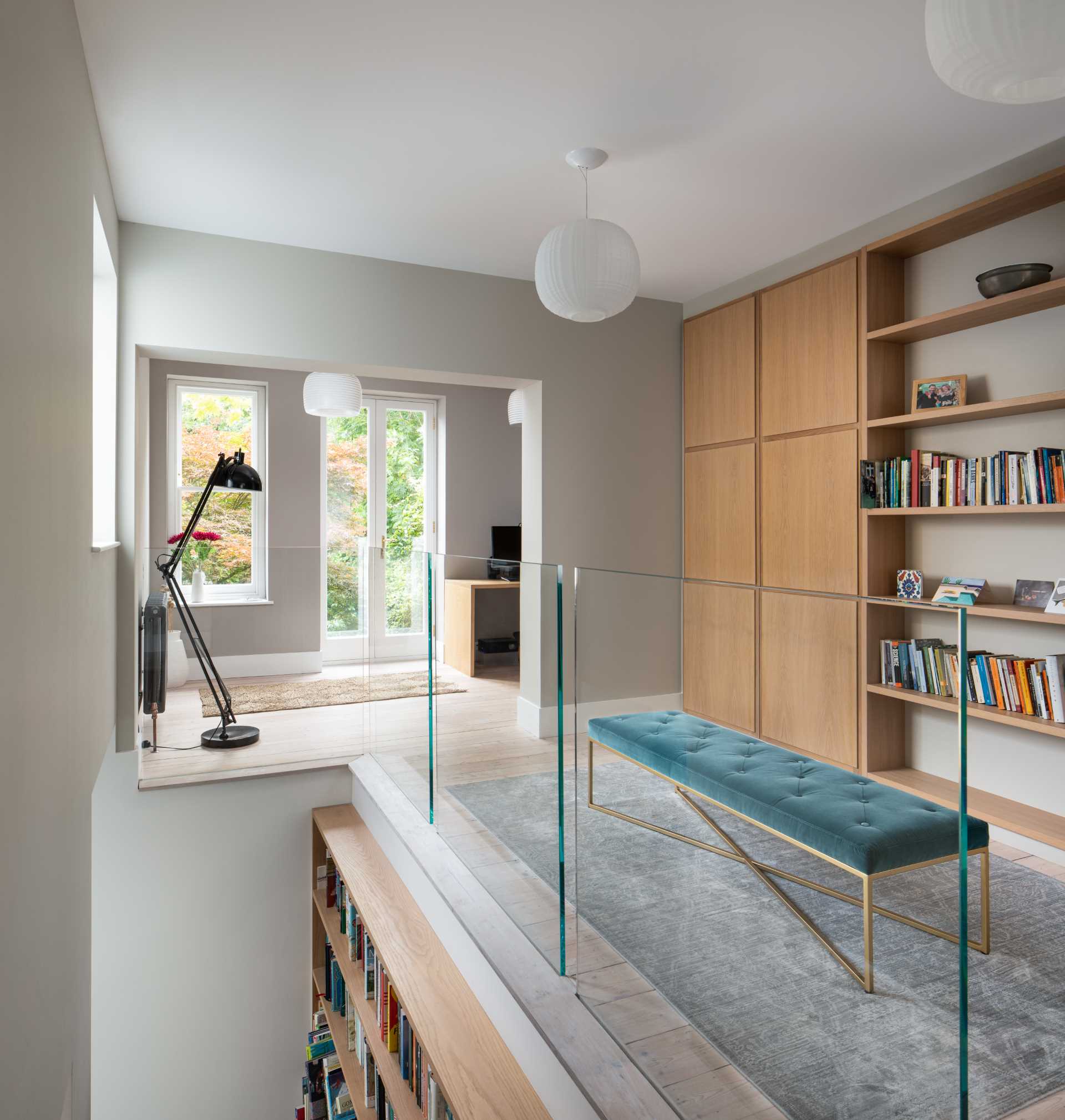 Glass railings allow the natural light to pass throughout this interior.