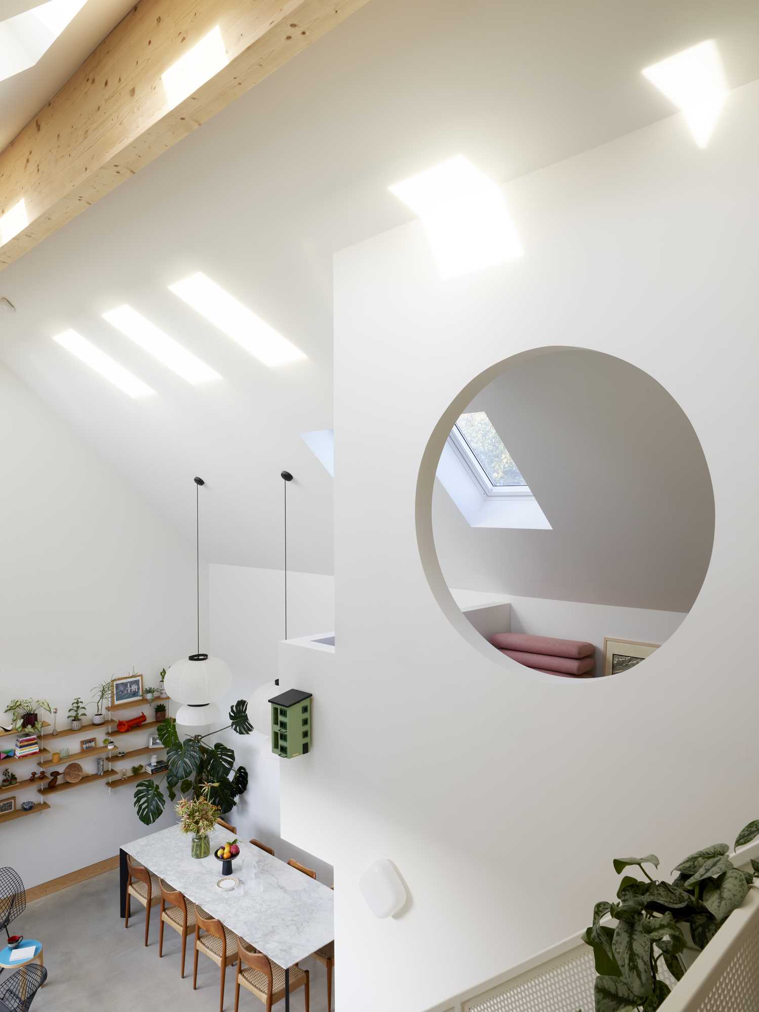 Stairs lead up to a lofted area, while the skylights add natural light throughout the interior.
