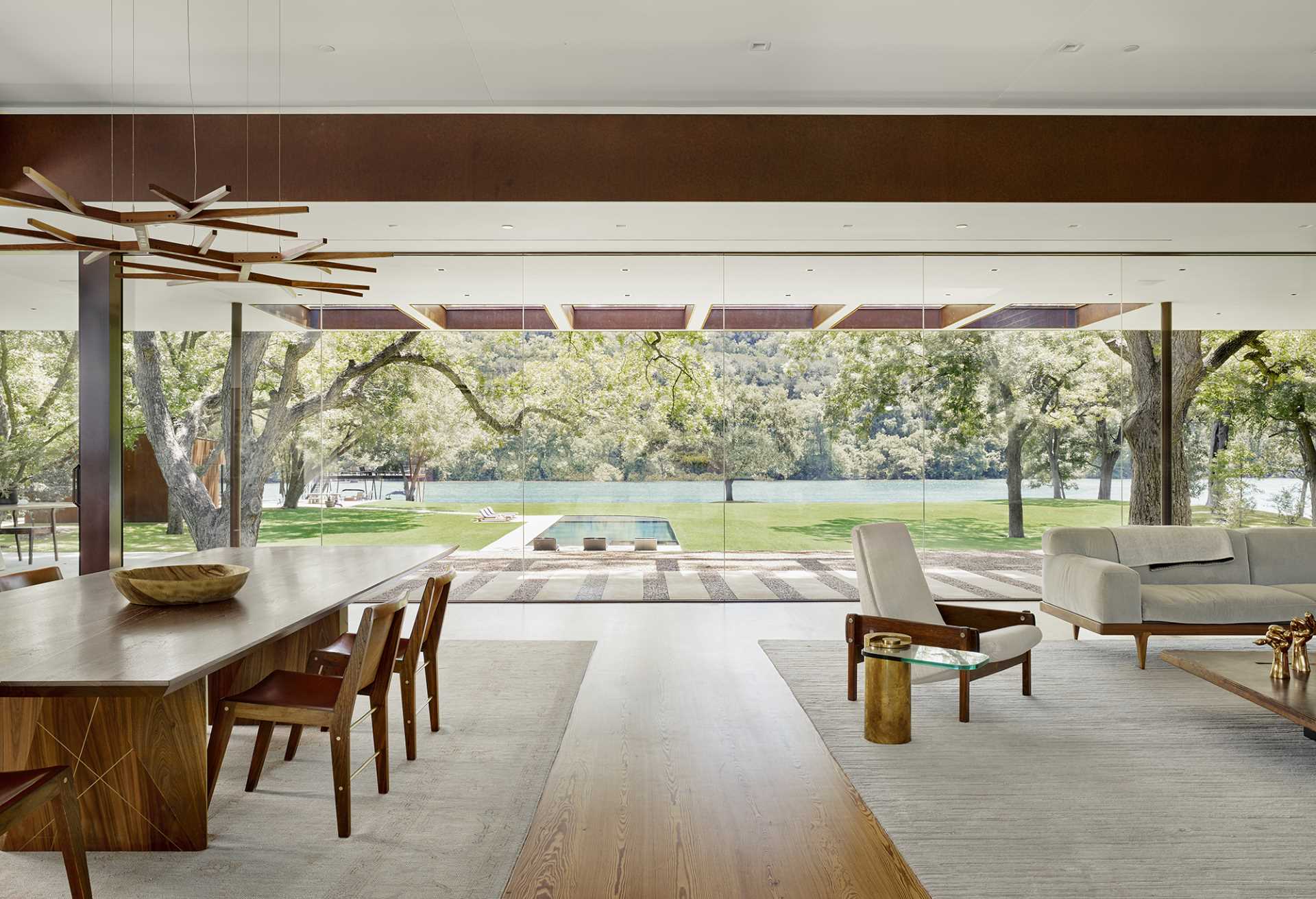 The centerpiece of the residence is the 1,000-square-foot great room that includes two walls of butt-glazed, floor-to-ceiling glass allowing views from and through the main living spaces to the landscape, while deep overhangs protect the interiors from the harsh summer sun.