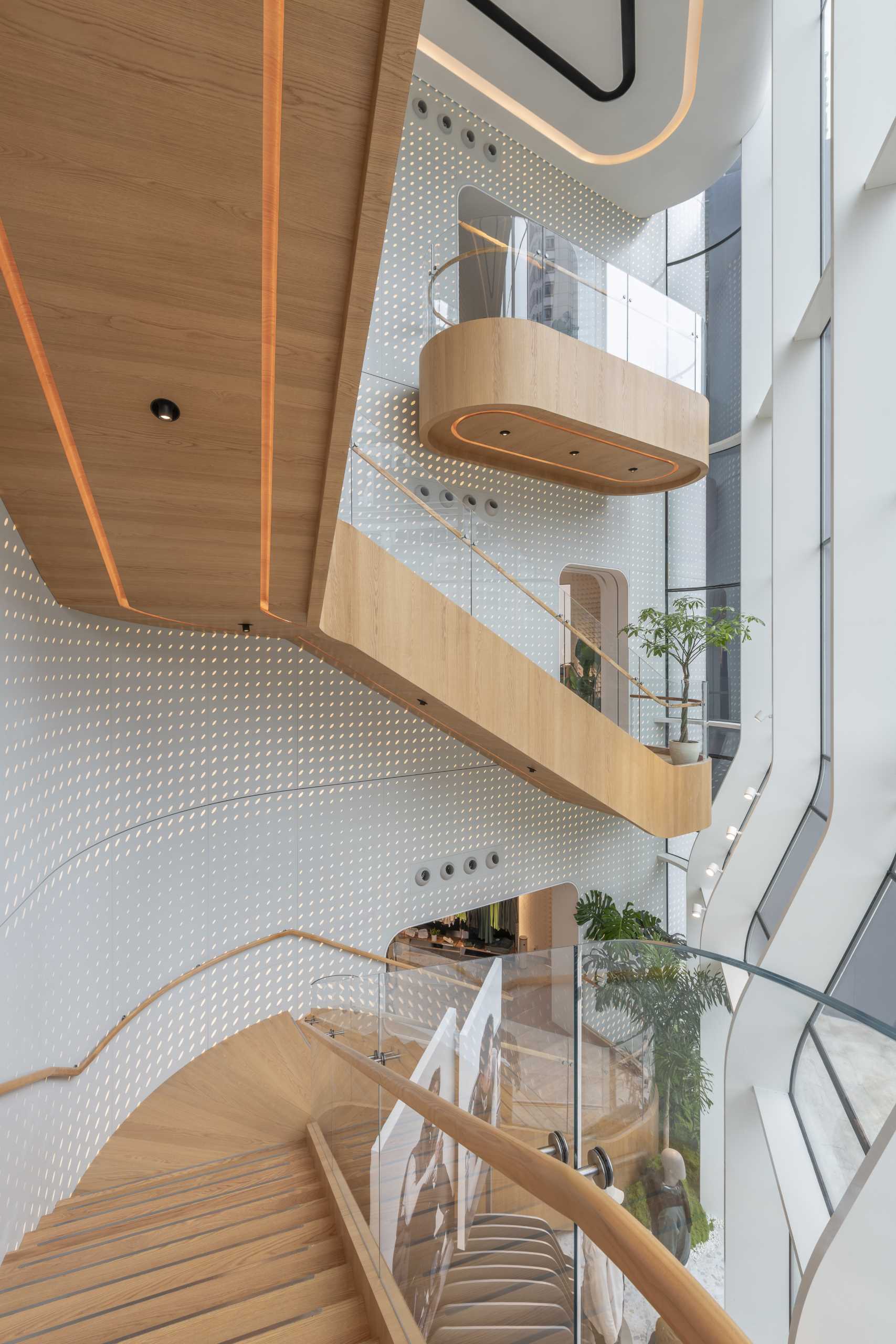 A modern Lululemon flag،p store has curved and patterned walls with a large staircase that connects the multiple floors.