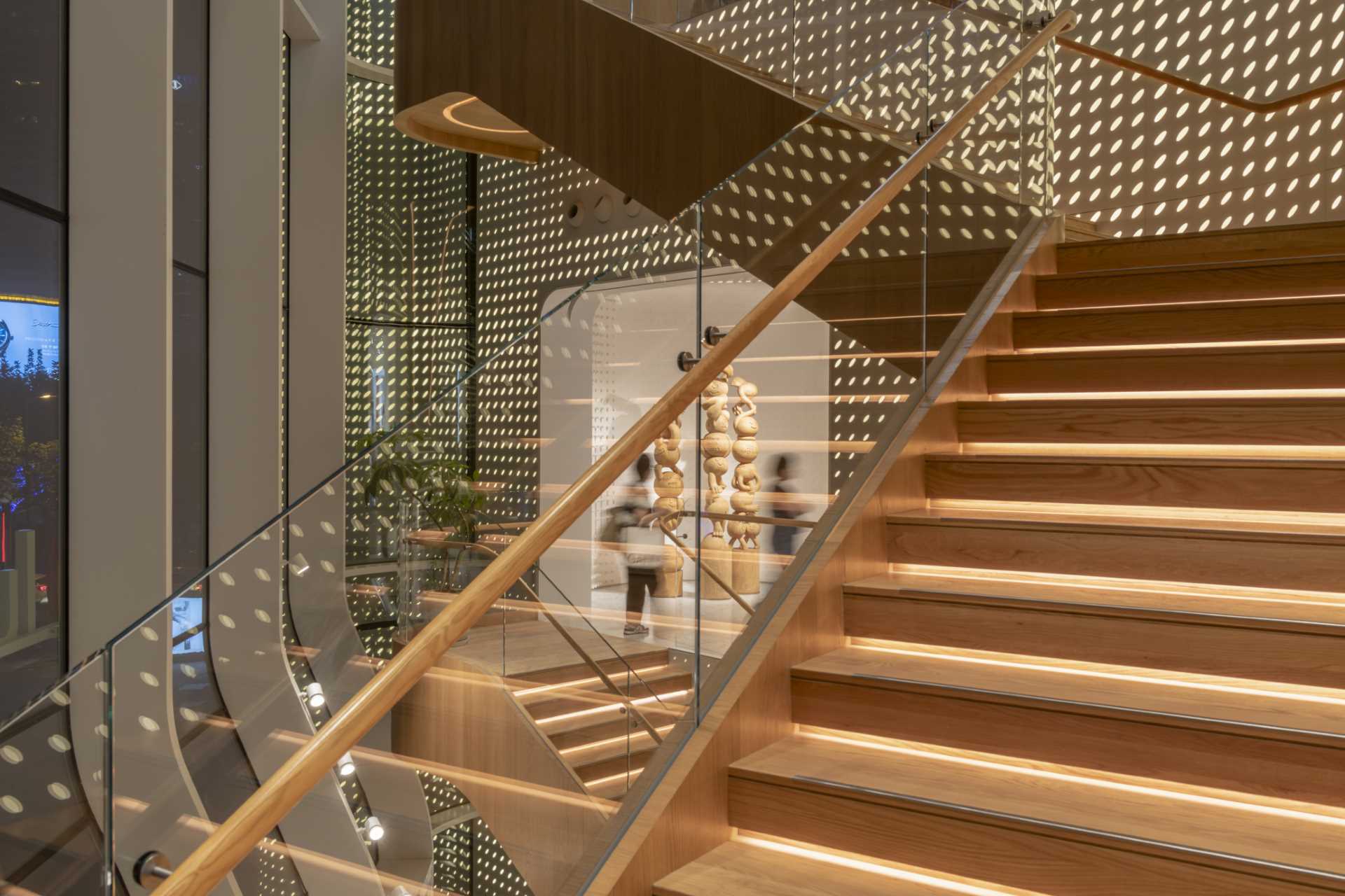 A modern Lululemon flag،p store has curved and patterned walls with a large staircase that connects the multiple floors.