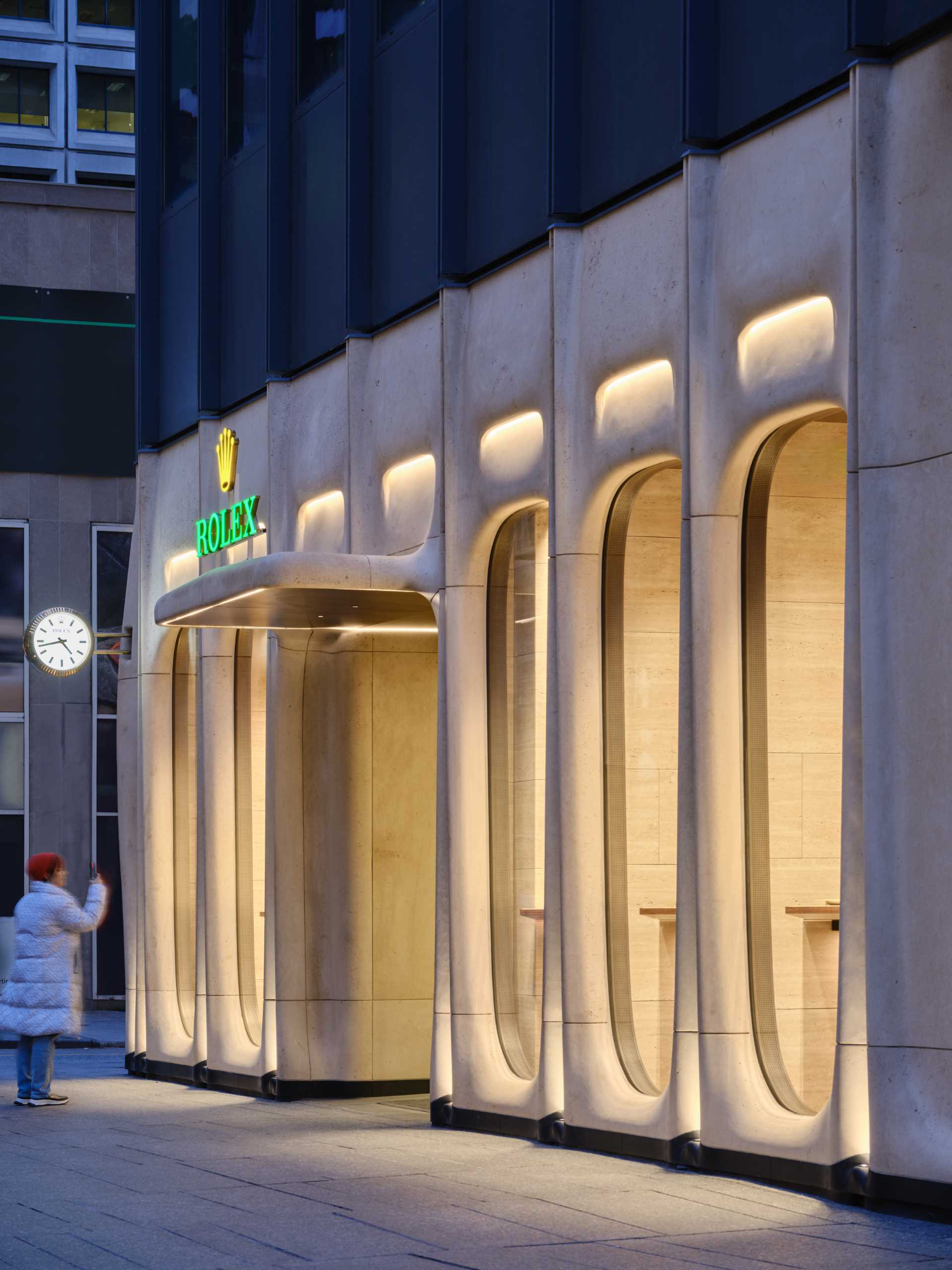 A modern retail boutique with a sculptural limestone facade.