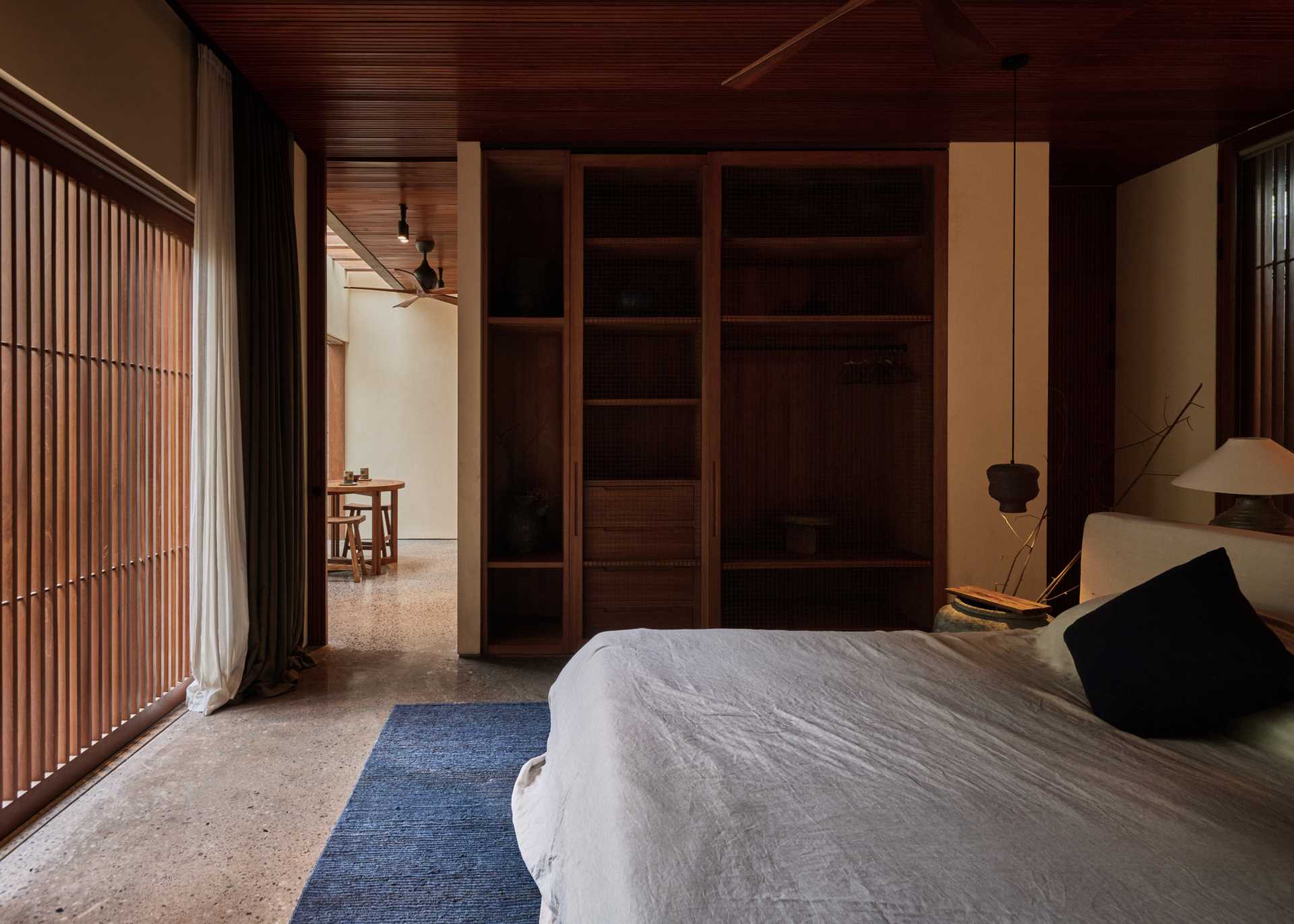 In this bedroom, a custom closet complements the wood slats and ceiling.