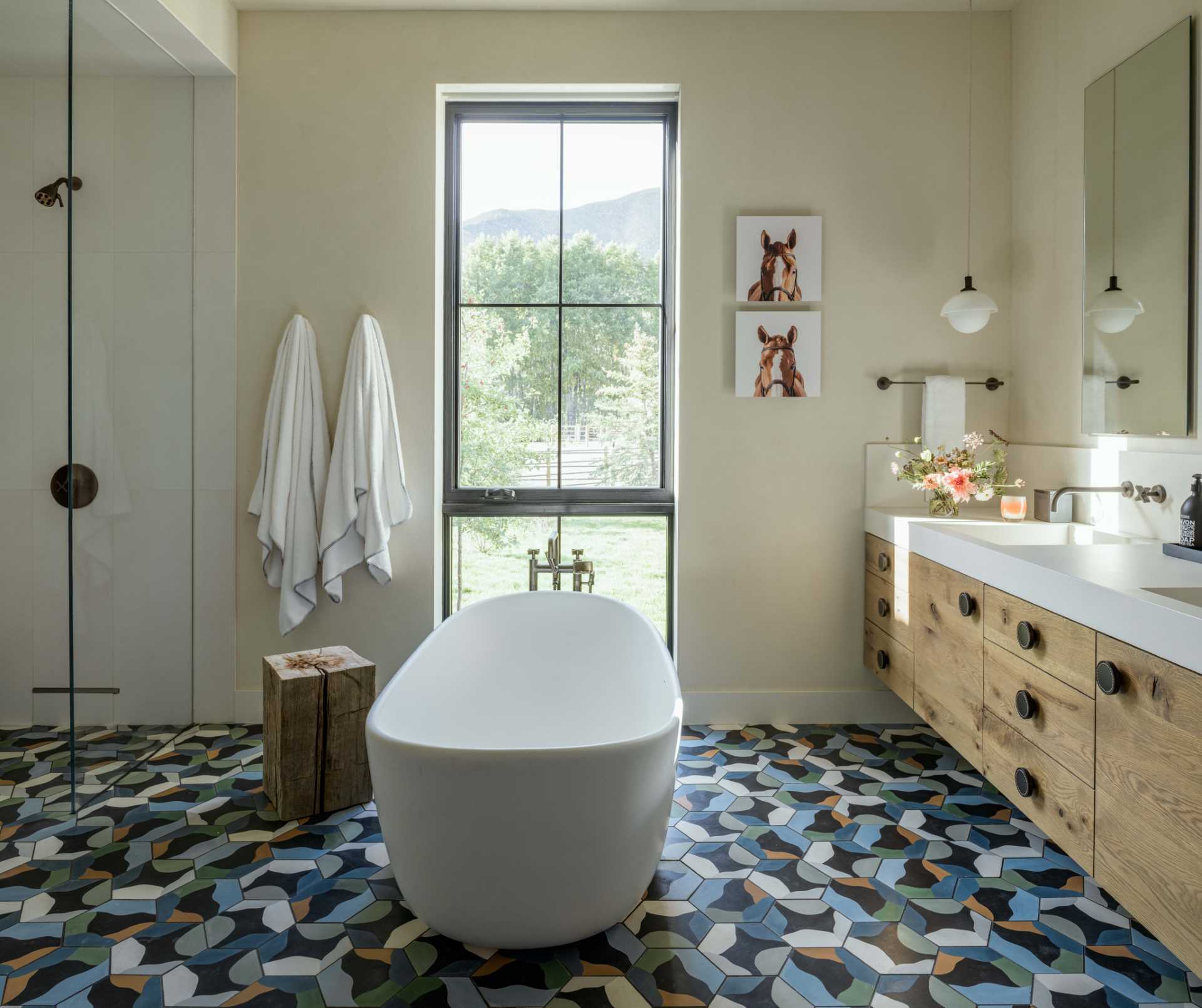 In this contemporary bathroom, the bathtub is positioned to take advantage of views through the Dutch window.