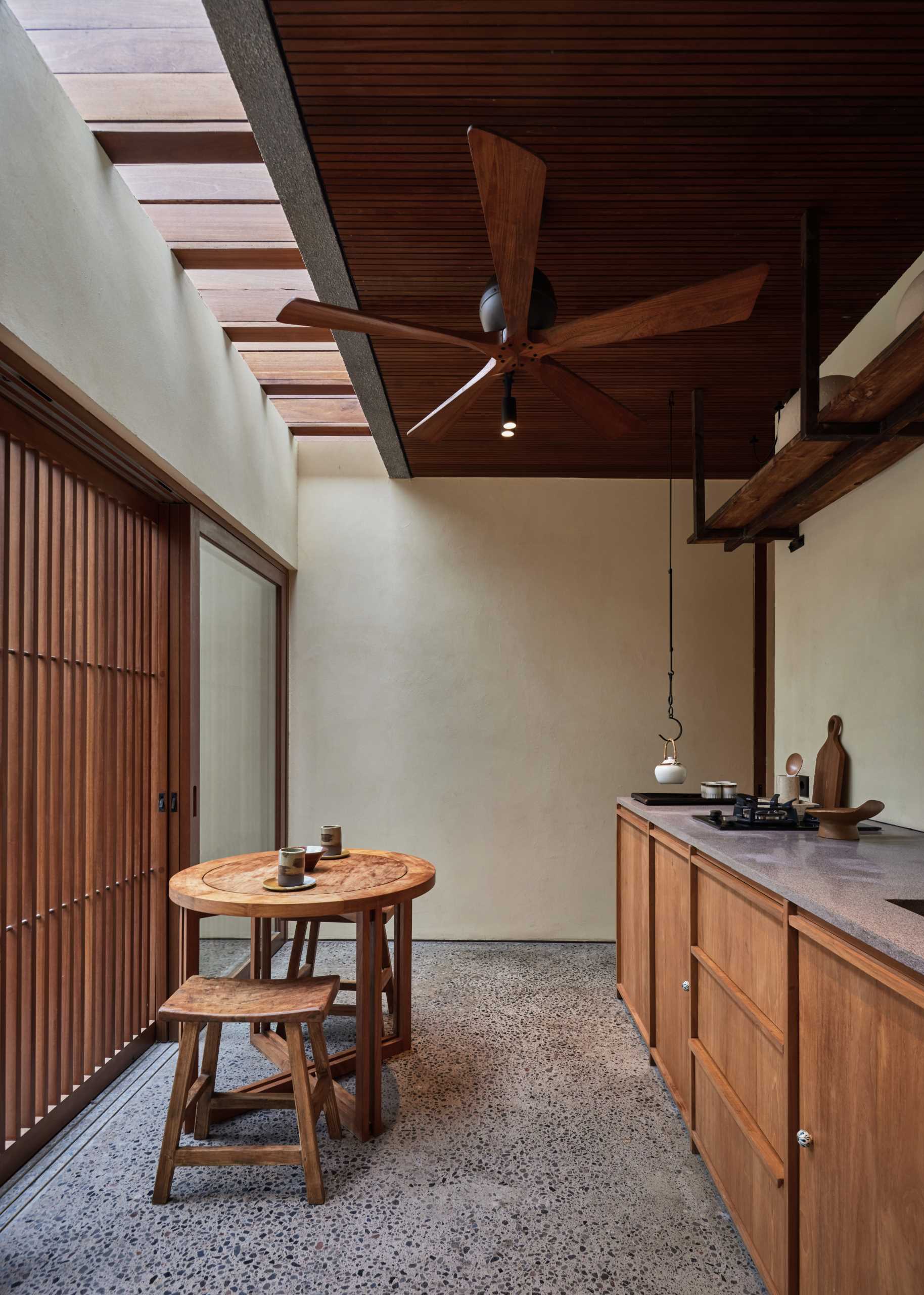 A small tea room with wood cabinetry.