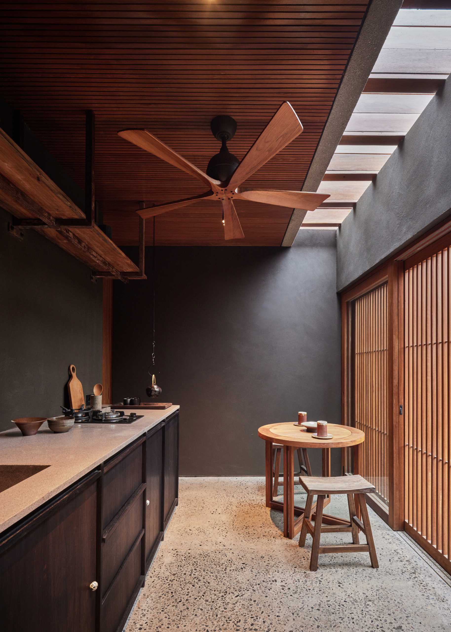 A small tea room with wood cabinetry.