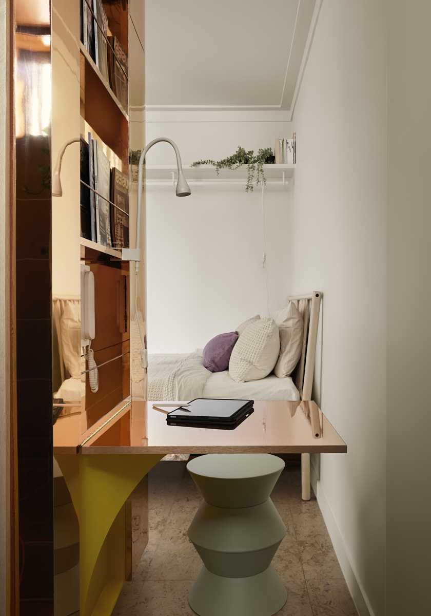 A fold-down desk makes the most of the space in a micro apartment.