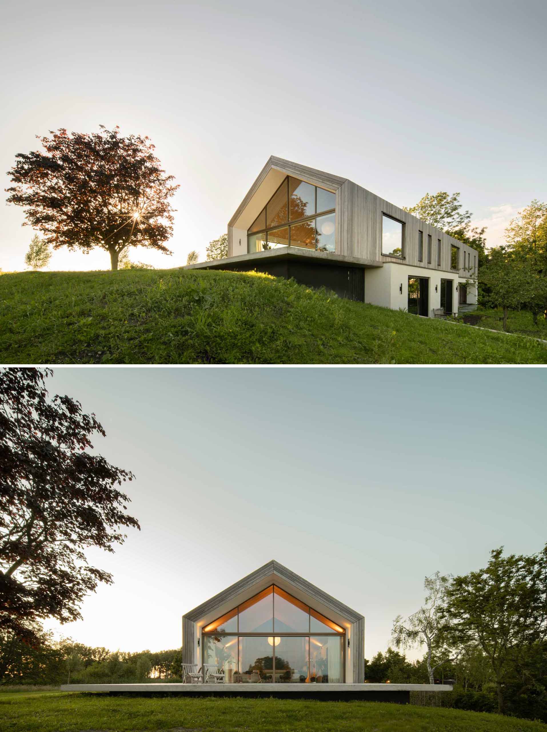 A modern barn-inspired home with a gabled-roof and glass walls.