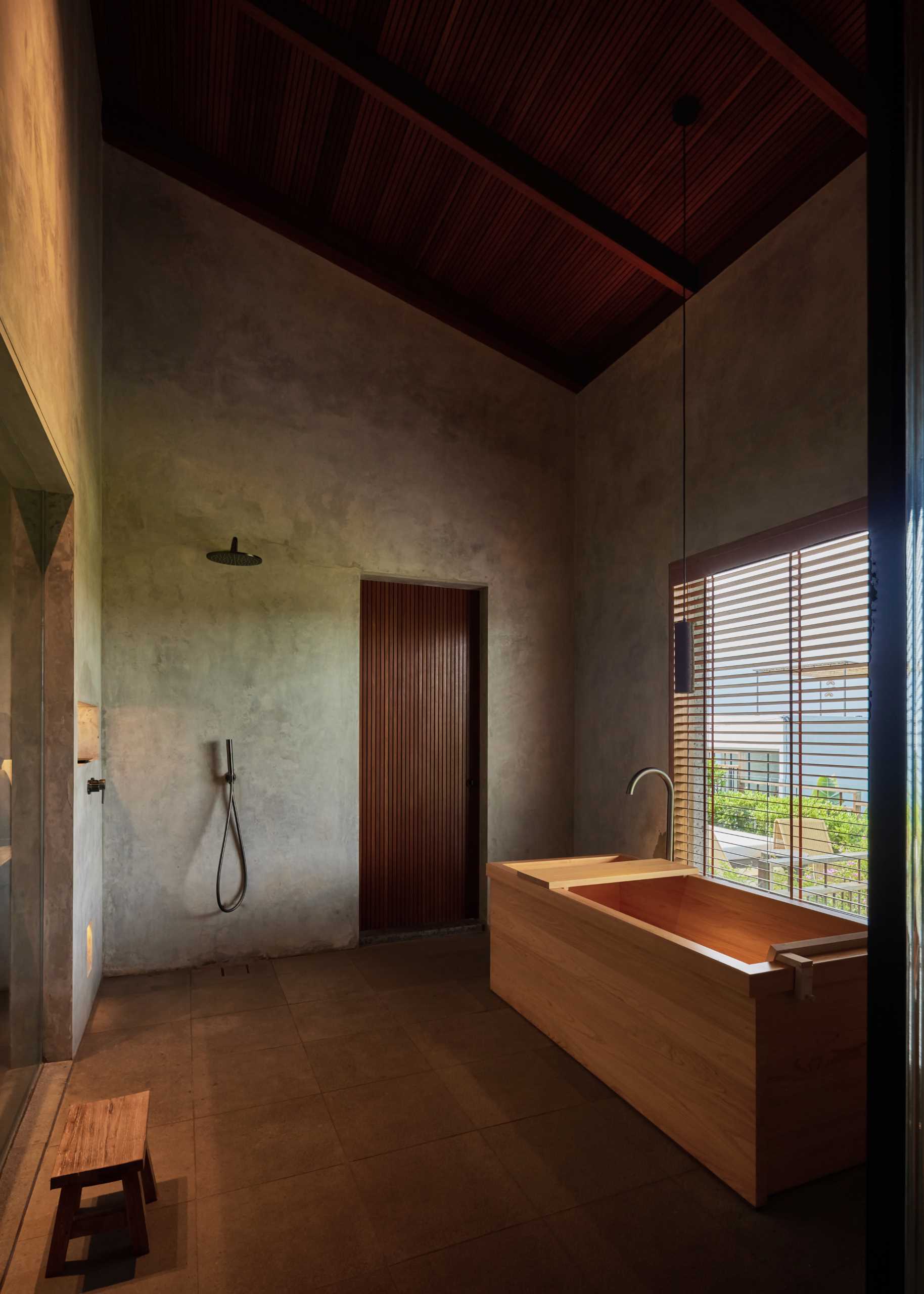 Japanese-inspired bathroom with deep a wood soaking tub.