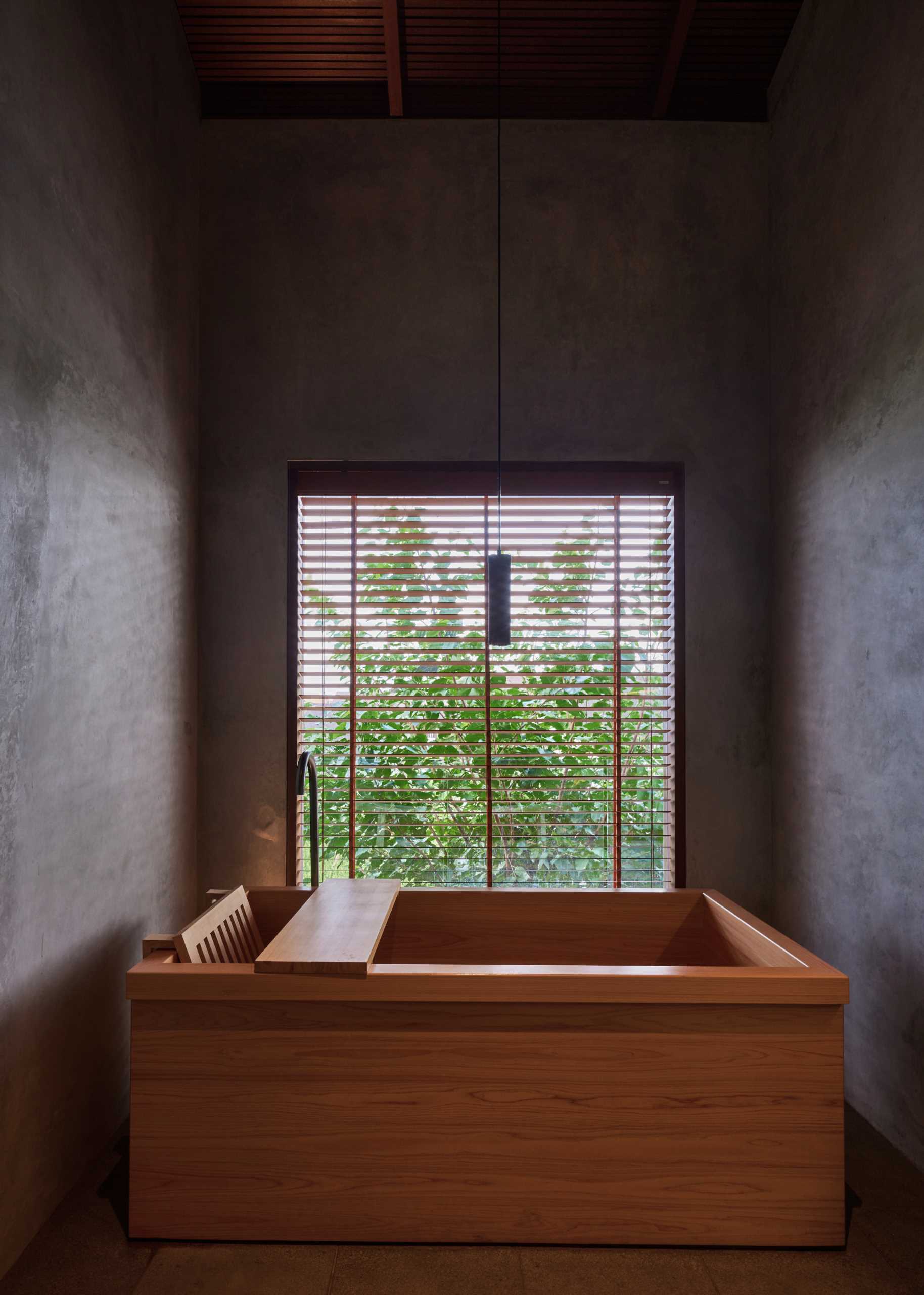 Japanese-inspired bathroom with deep a wood soaking tub.