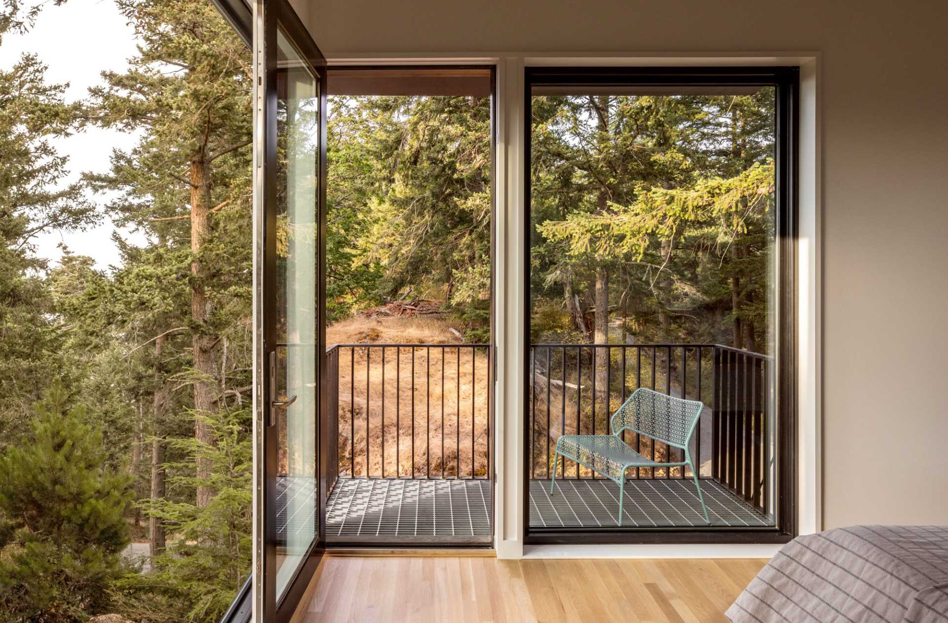 A modern bedroom that opens to a private balcony.