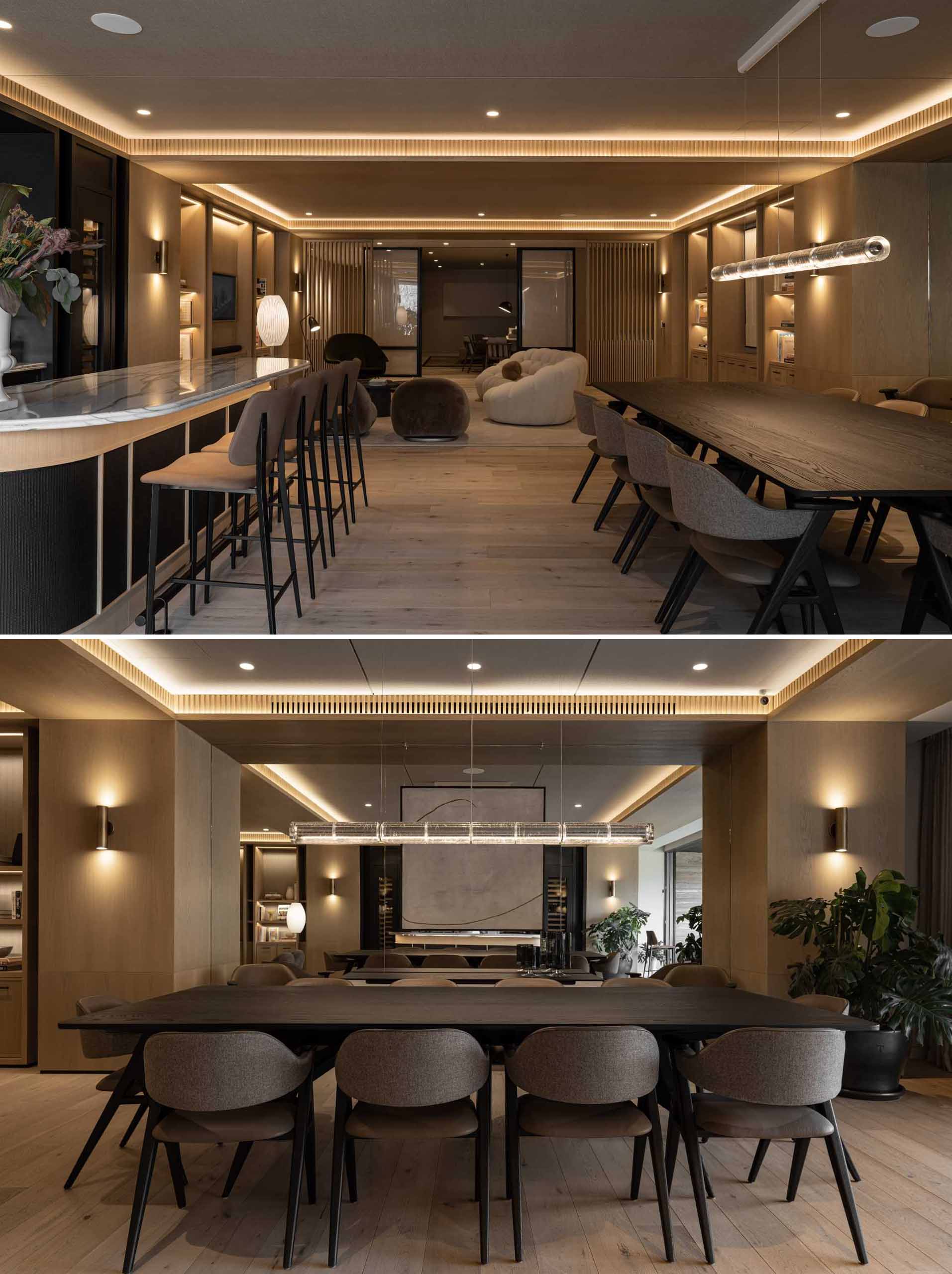 In this modern kitchen, lighting has been hidden underneath the countertop overhang on the island, whereas the dining room has a mirrored wall and features the Luana chair from Piztola, with its dark wood and leather tones, adding a touch of sophistication.