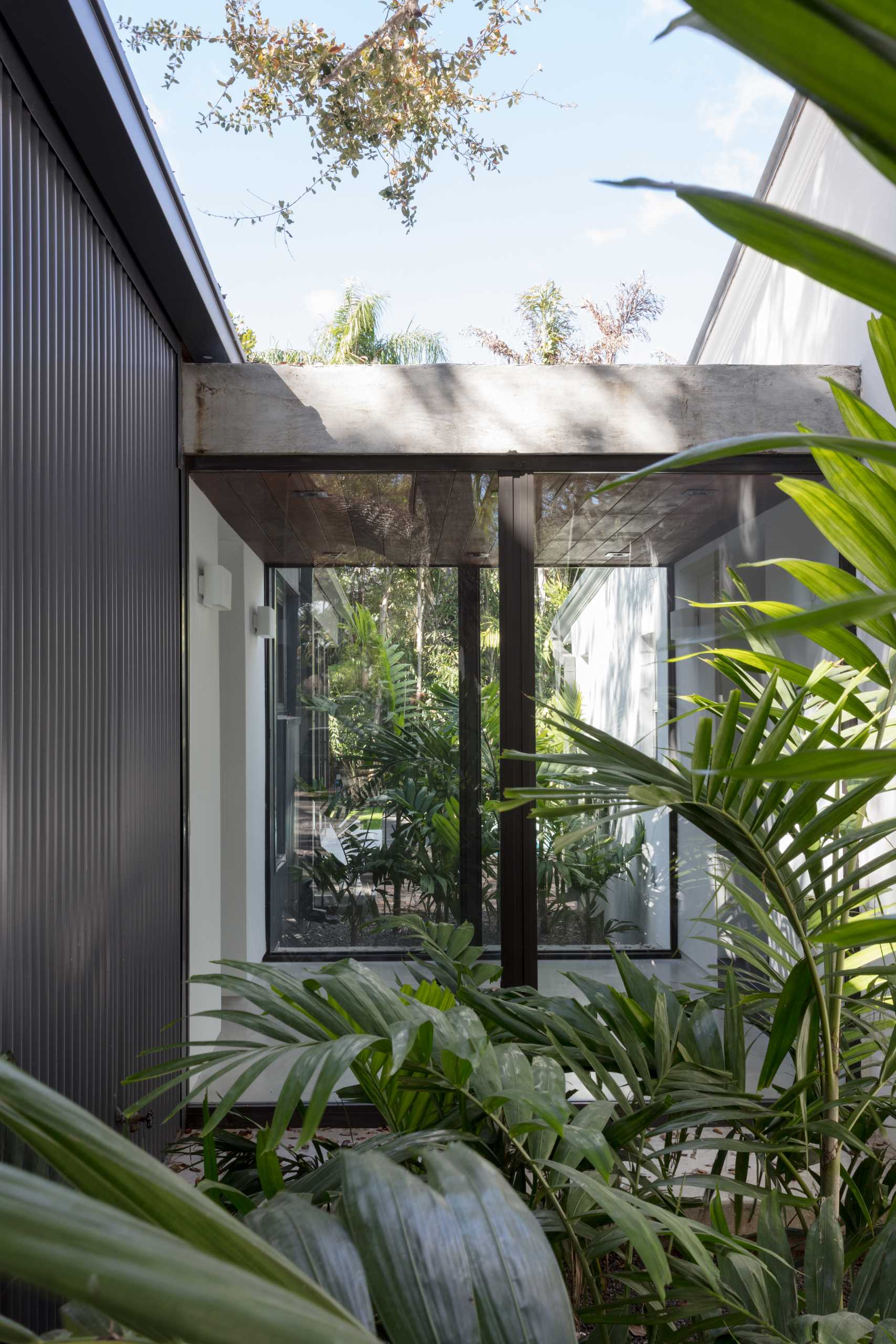 A connecting hallway with walls of glass connects the original house with the new extension.