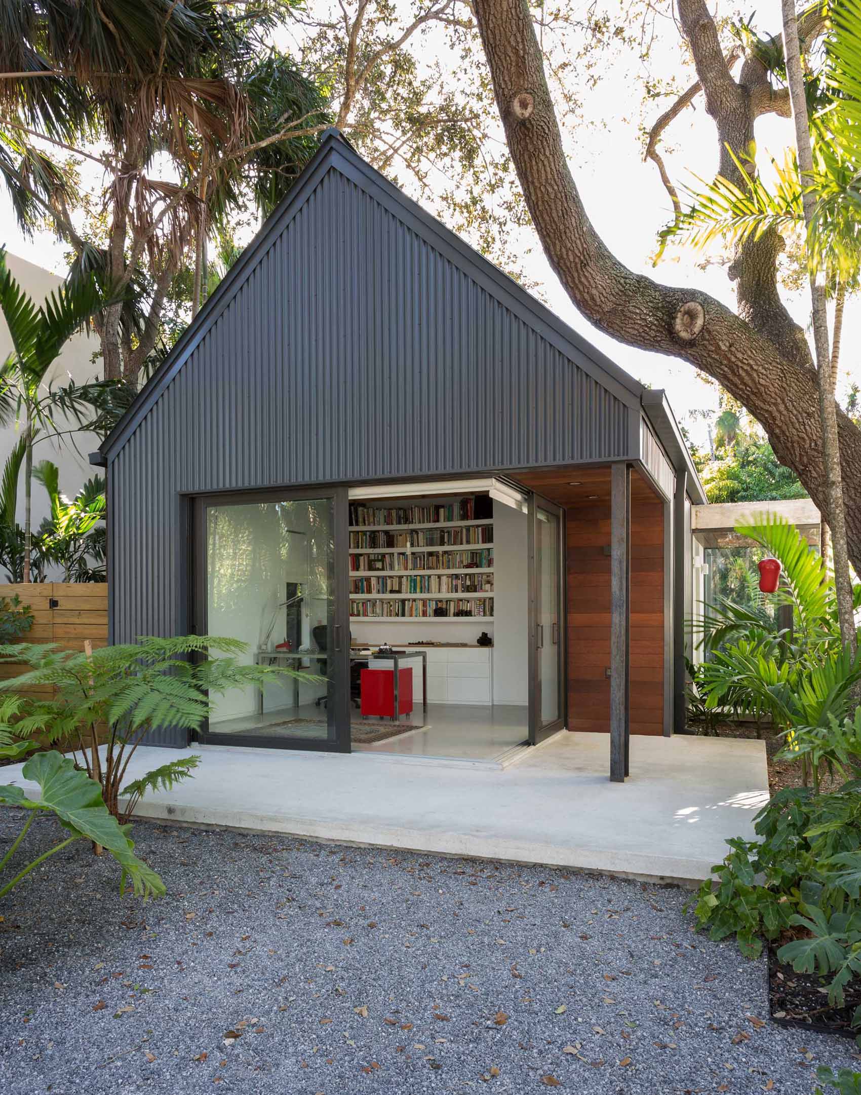 This new home office/studio connects with the front yard with a pair of sliding doors that open the corner of the space.