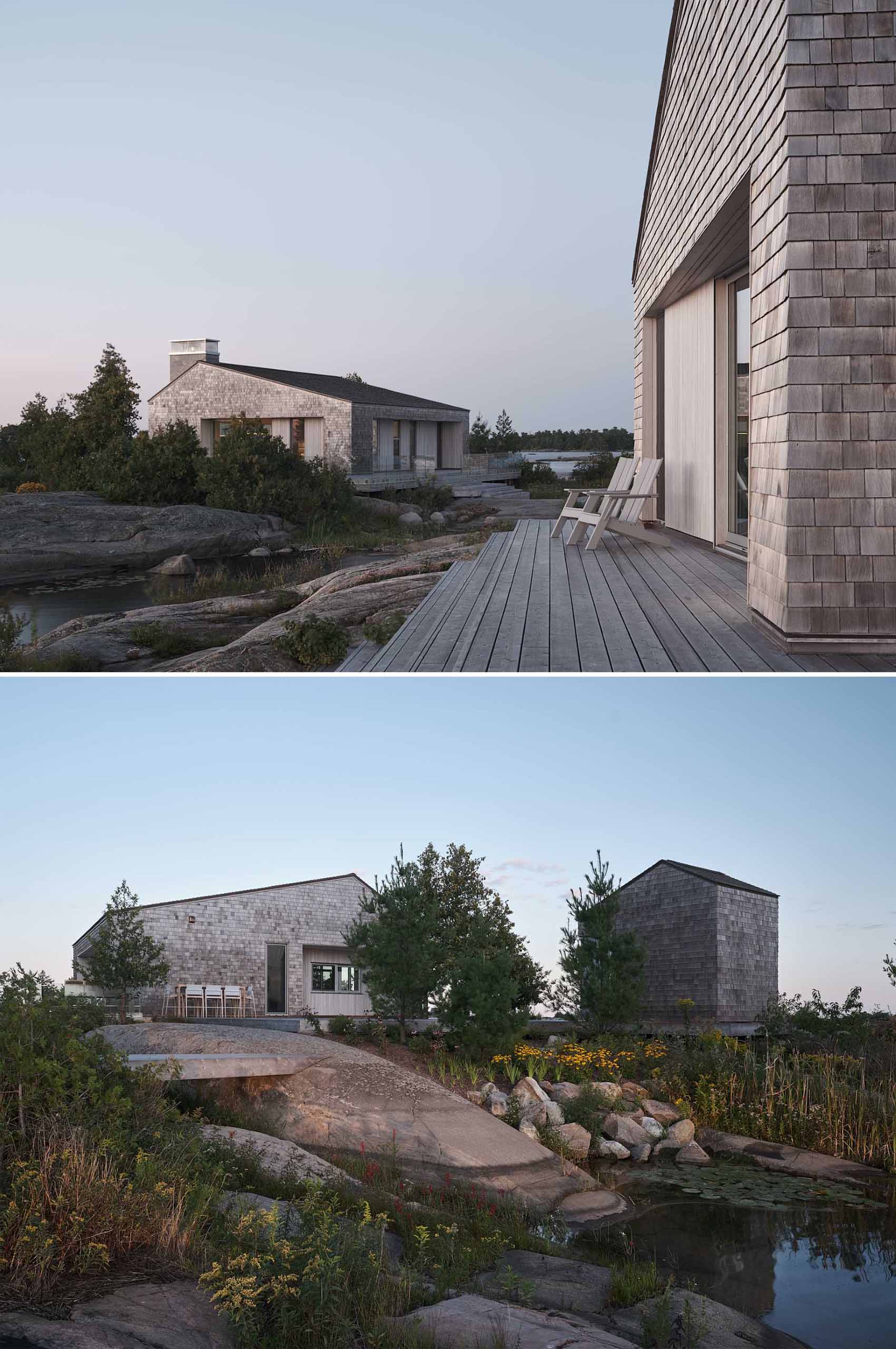 A contemporary cottage that comprises a cluster of buildings, each clad in shingles.