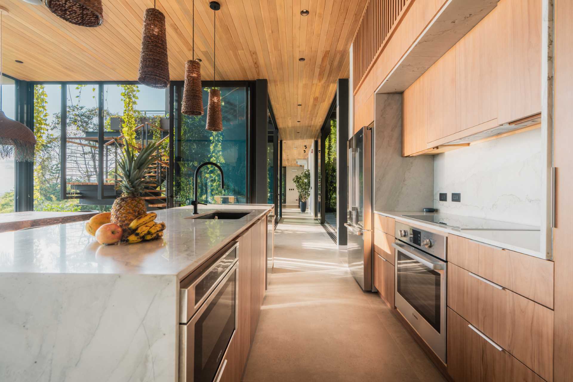 A modern wood kitchen with a large island.