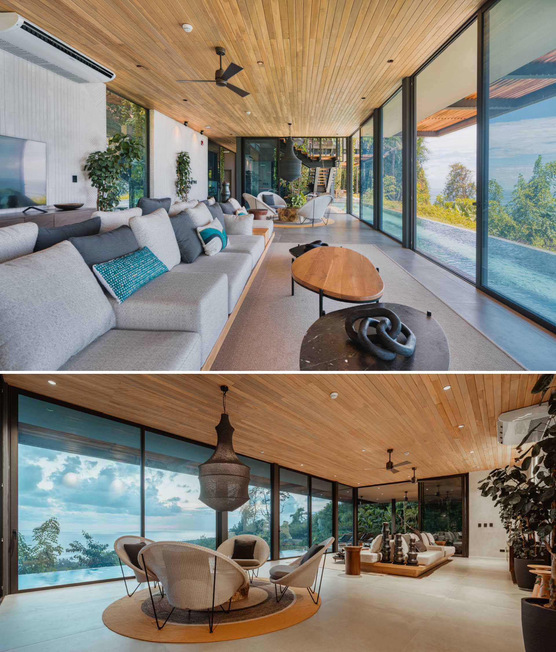 This modern living room has a double-sided couch for watching TV or watching the views, as well as a smaller sitting area with four chairs centered around a wood table and a sculptural pendant light.