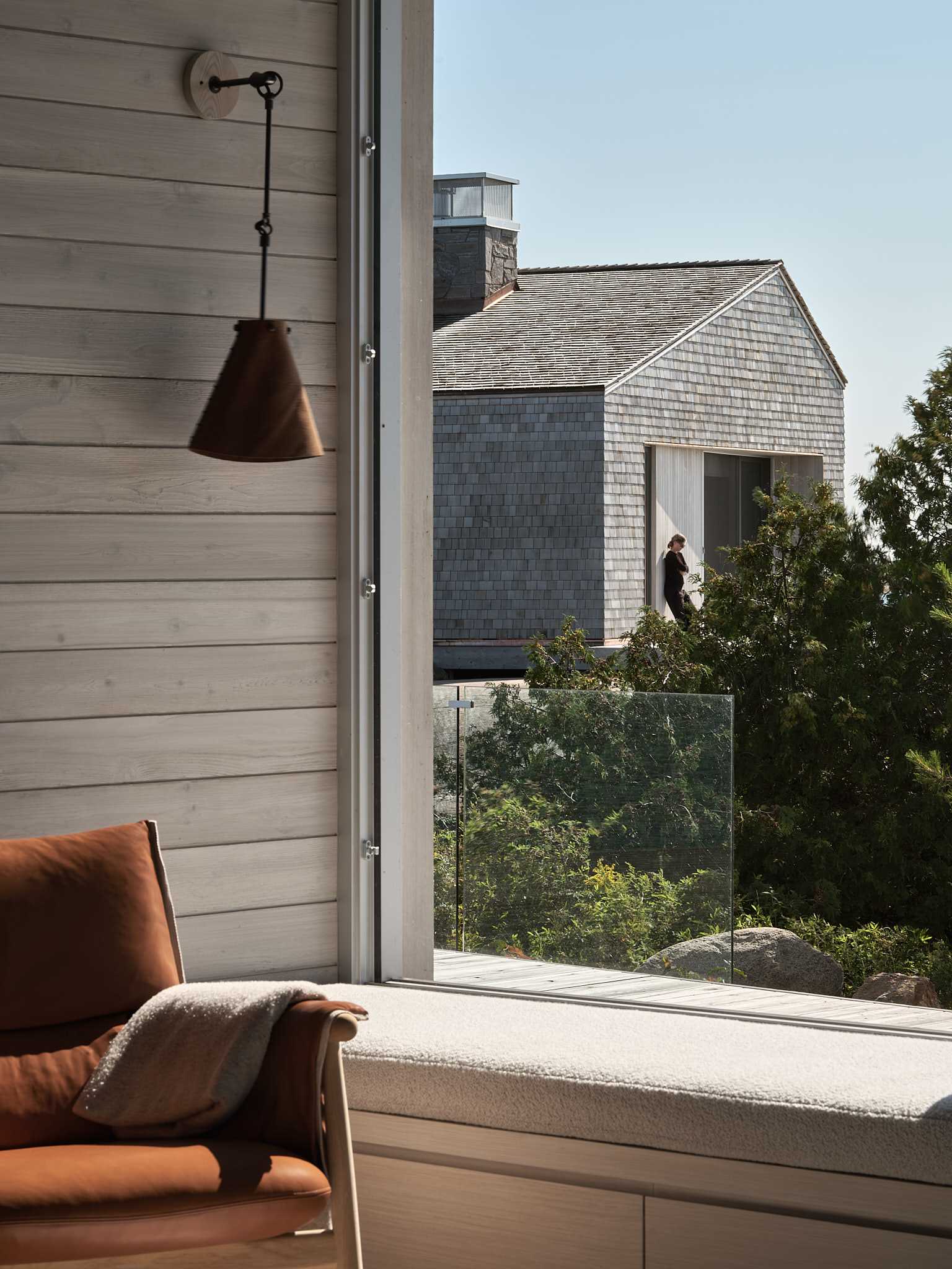 A modern cottage with a built-in window seat.