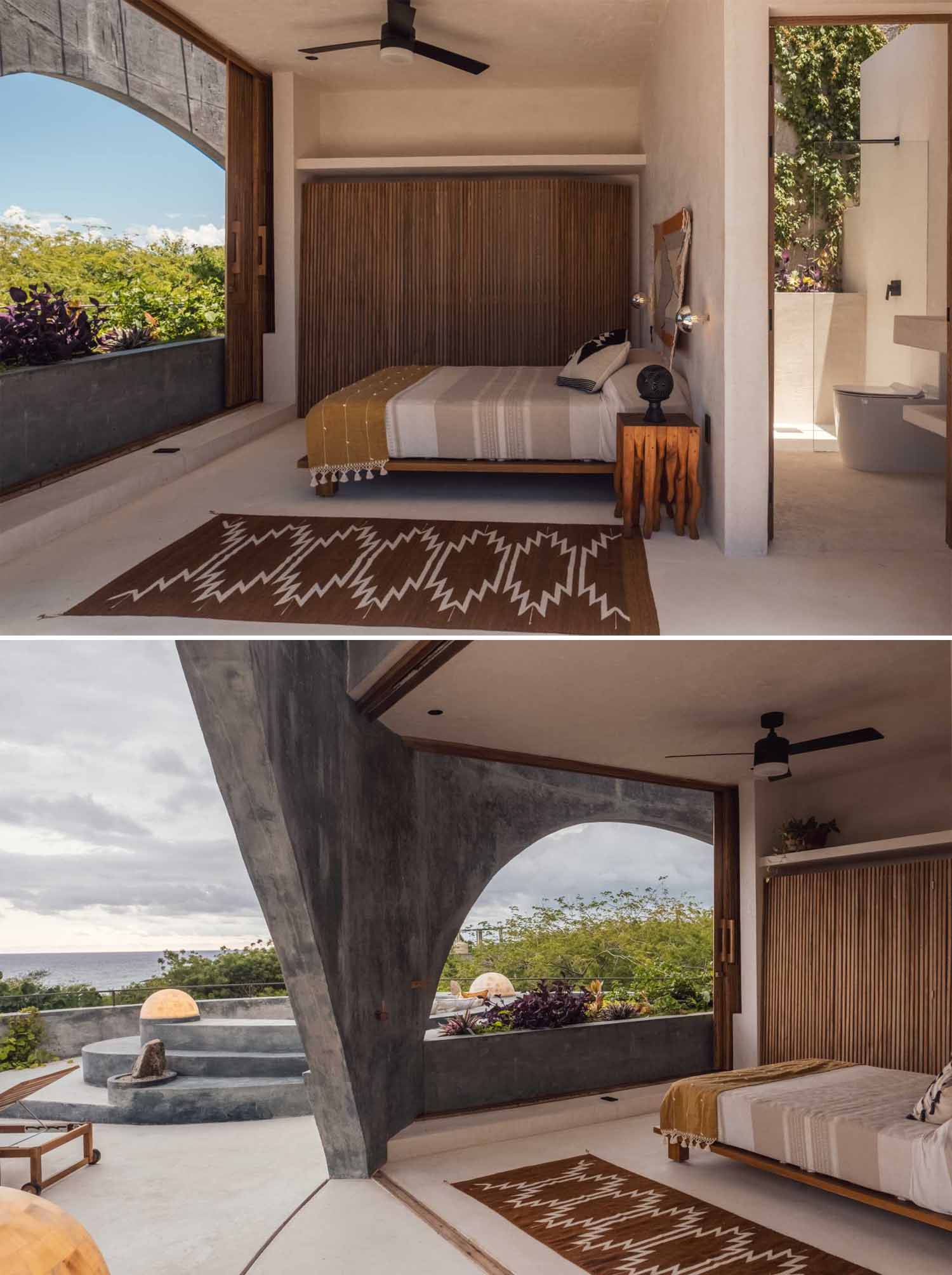 In the primary bedroom, large sliding wood panels open up the bedroom, and an en-suite bathroom is located behind the bedroom wall. The bedroom also connects to the rooftop terrace.