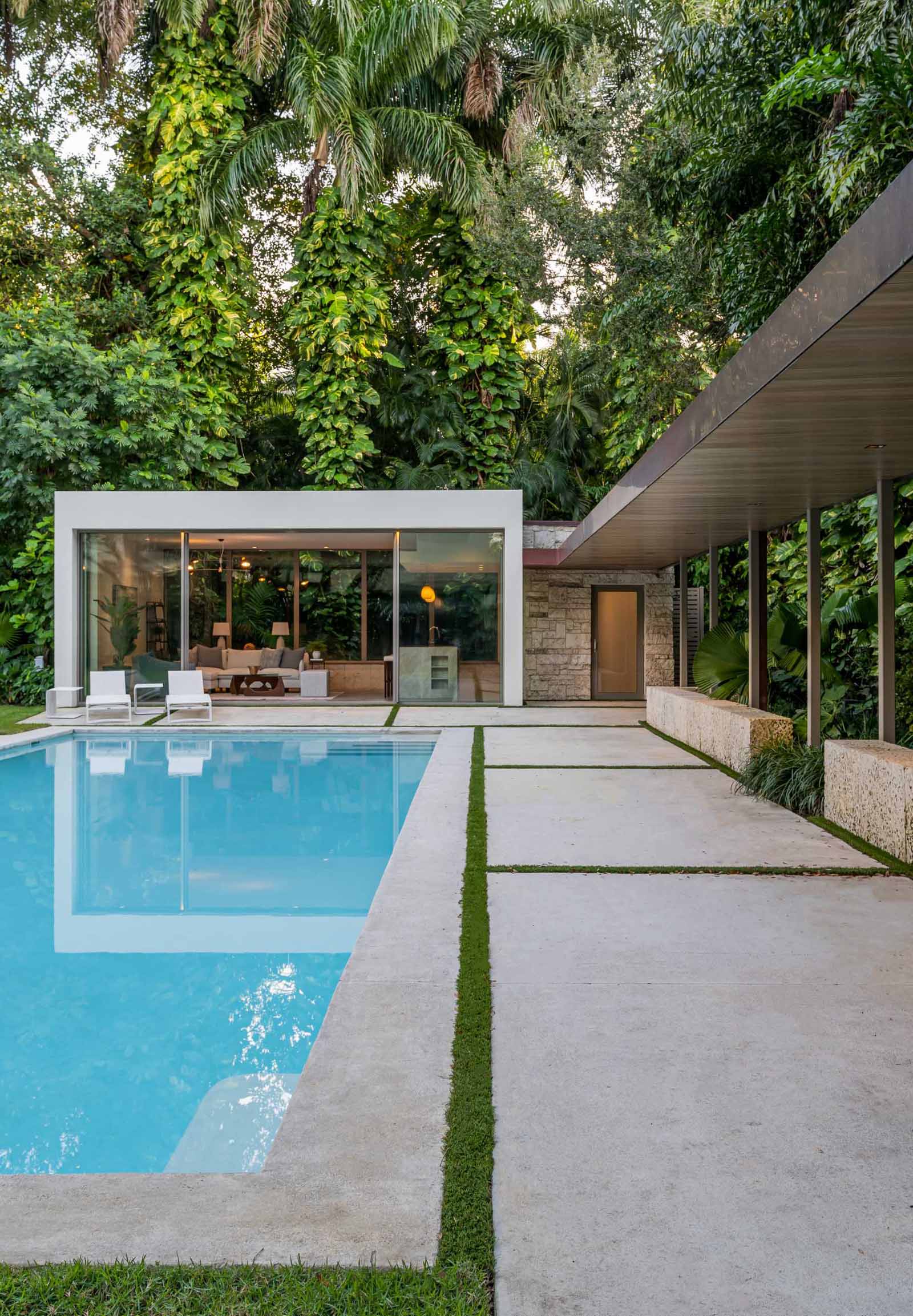 A modern backyard pavilion houses a living room, kitchen, and bathroom, and is connected to the home by a loggia (outdoor corridor).