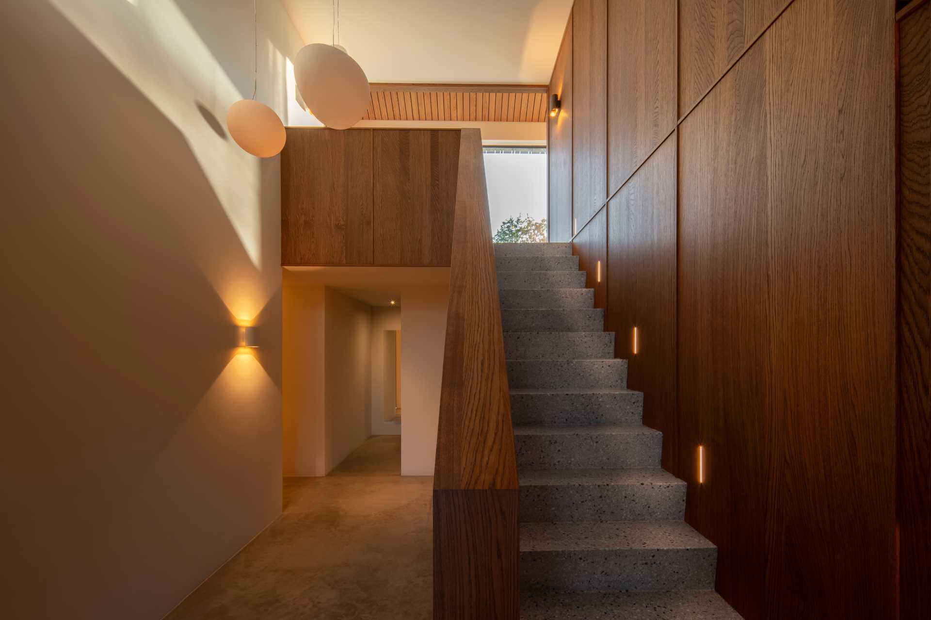 Terrazzo stairs lead up to the social areas of the home. 