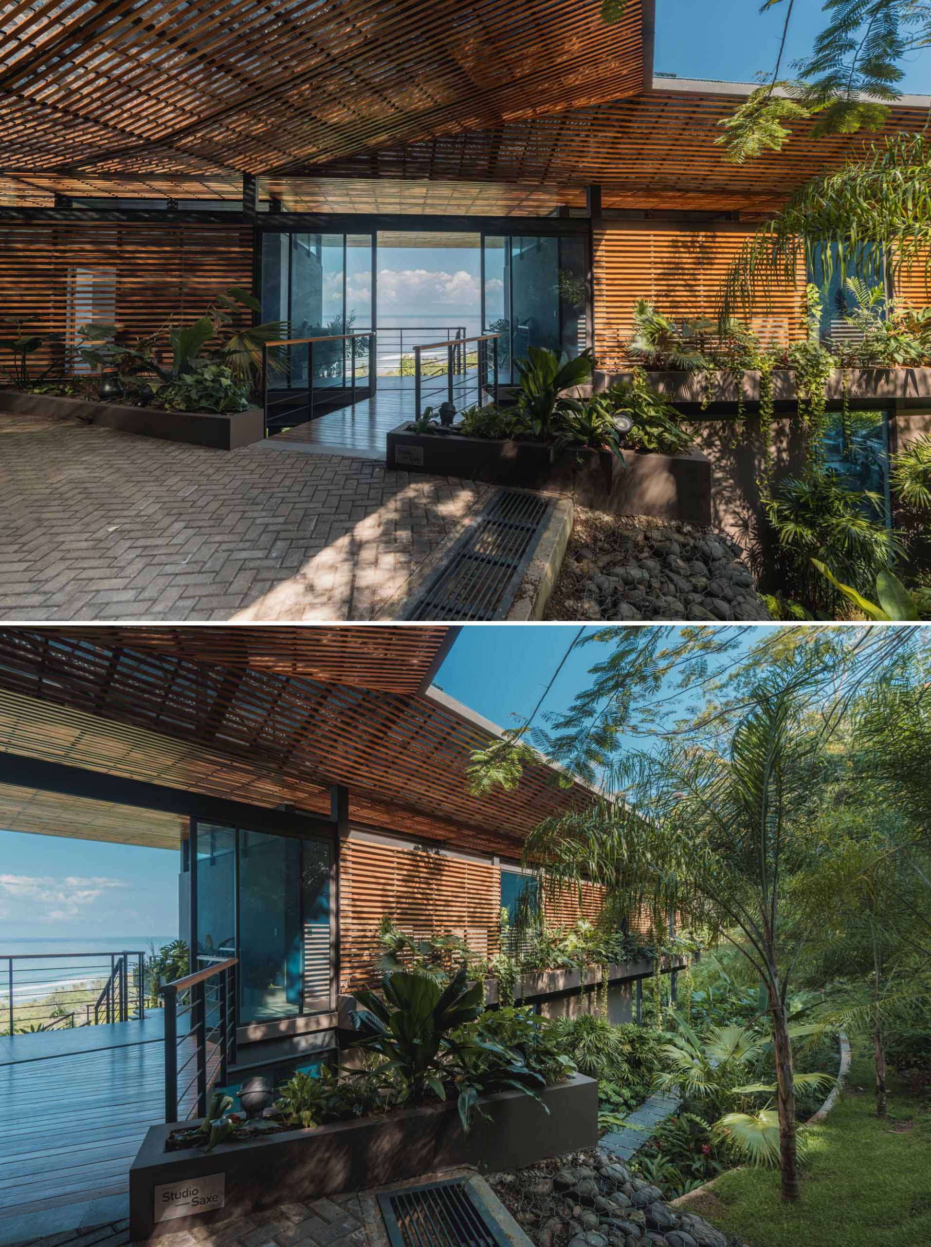 A wooden bridge suspended over a bamboo grove leads to the entryway with framed water views.