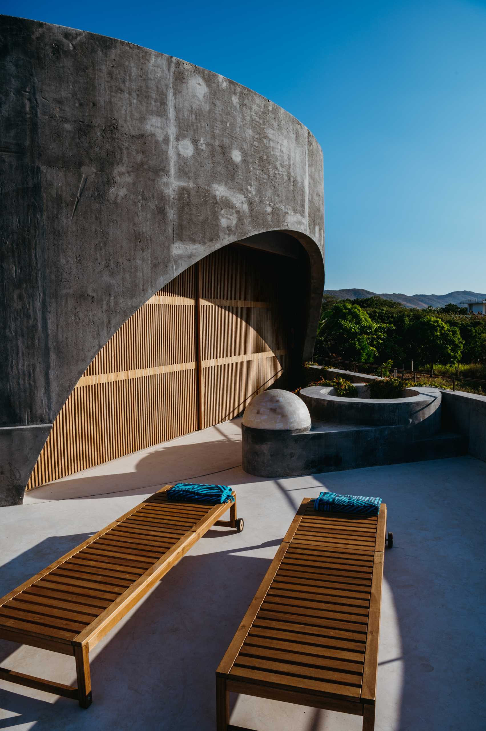 The modern rooftop terrace shows off the arches of the house design.