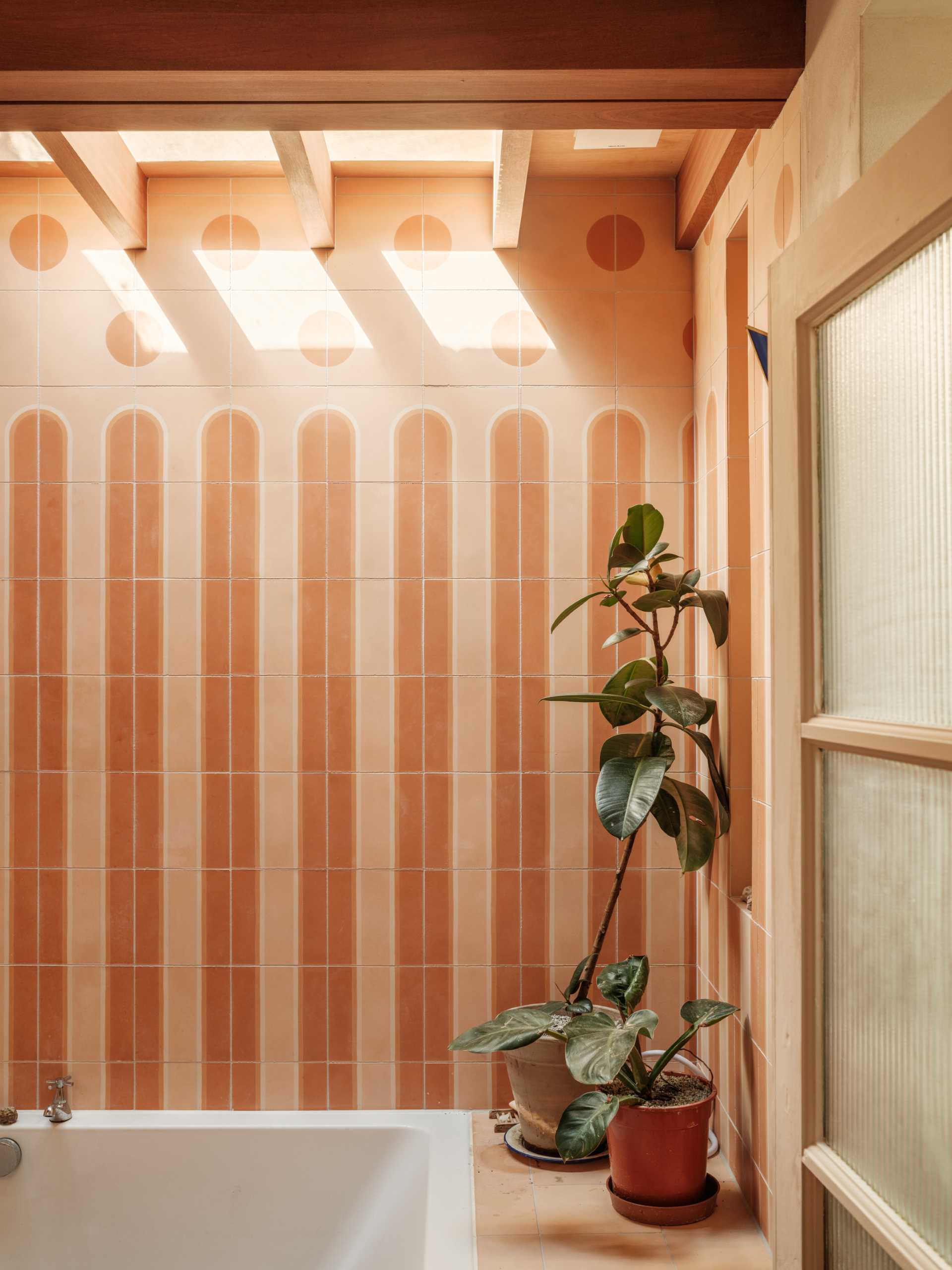 A new bathroom with tile-covered walls and a skylight.