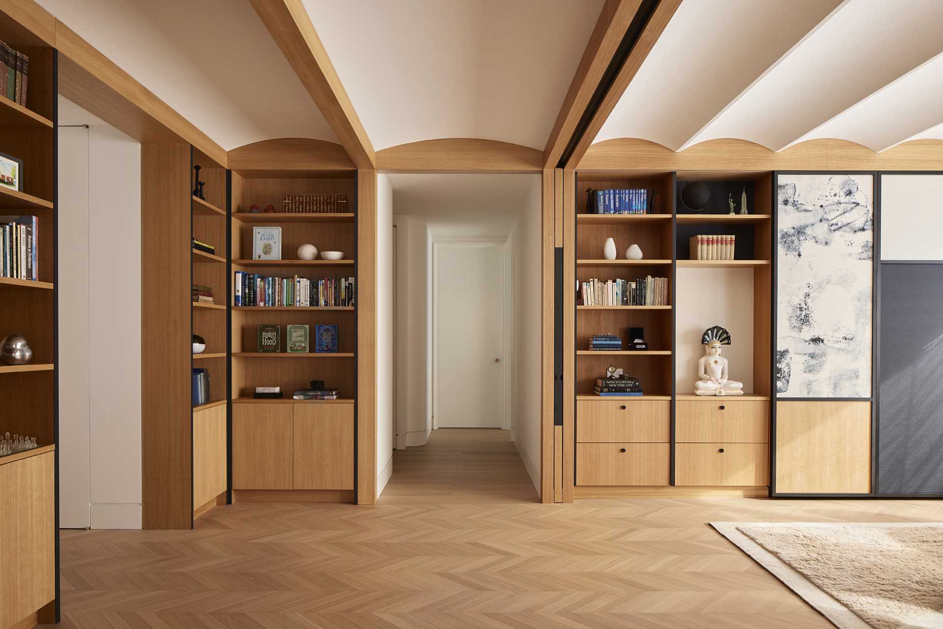 Wood and glass sliding doors allow the library to be open to the other areas of the apartment, or closed off for more privacy when being used as a guest room.