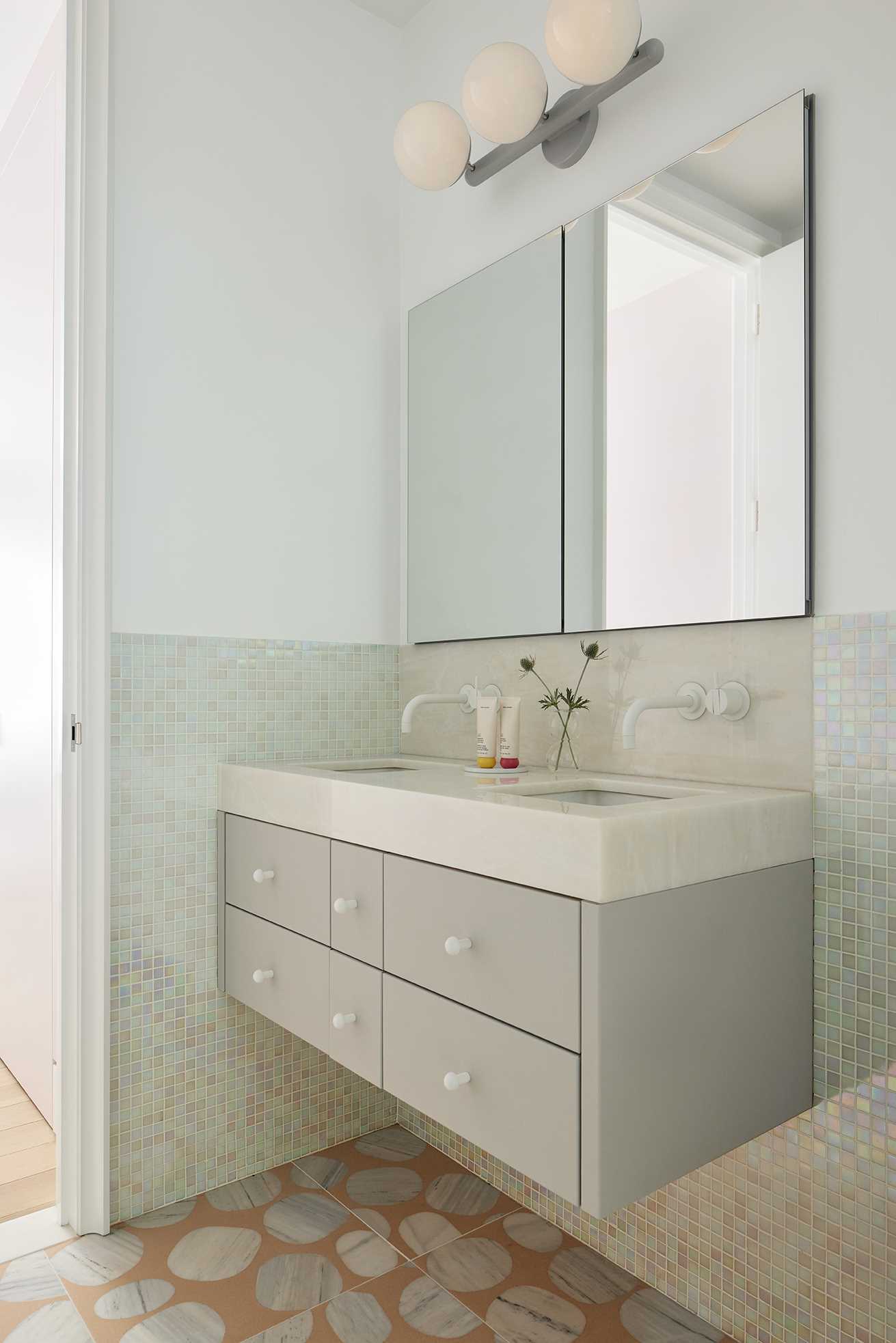 Light iridescent tiles create a fun look for this bathroom.