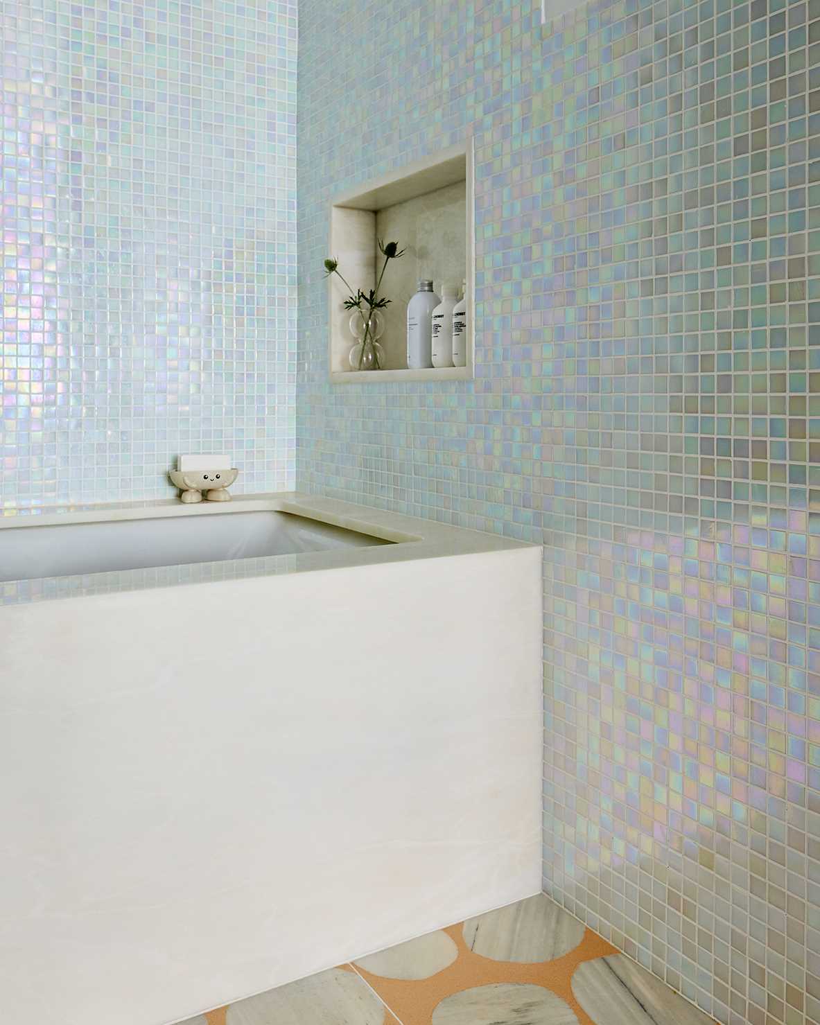 Light iridescent tiles create a fun look for this bathroom.