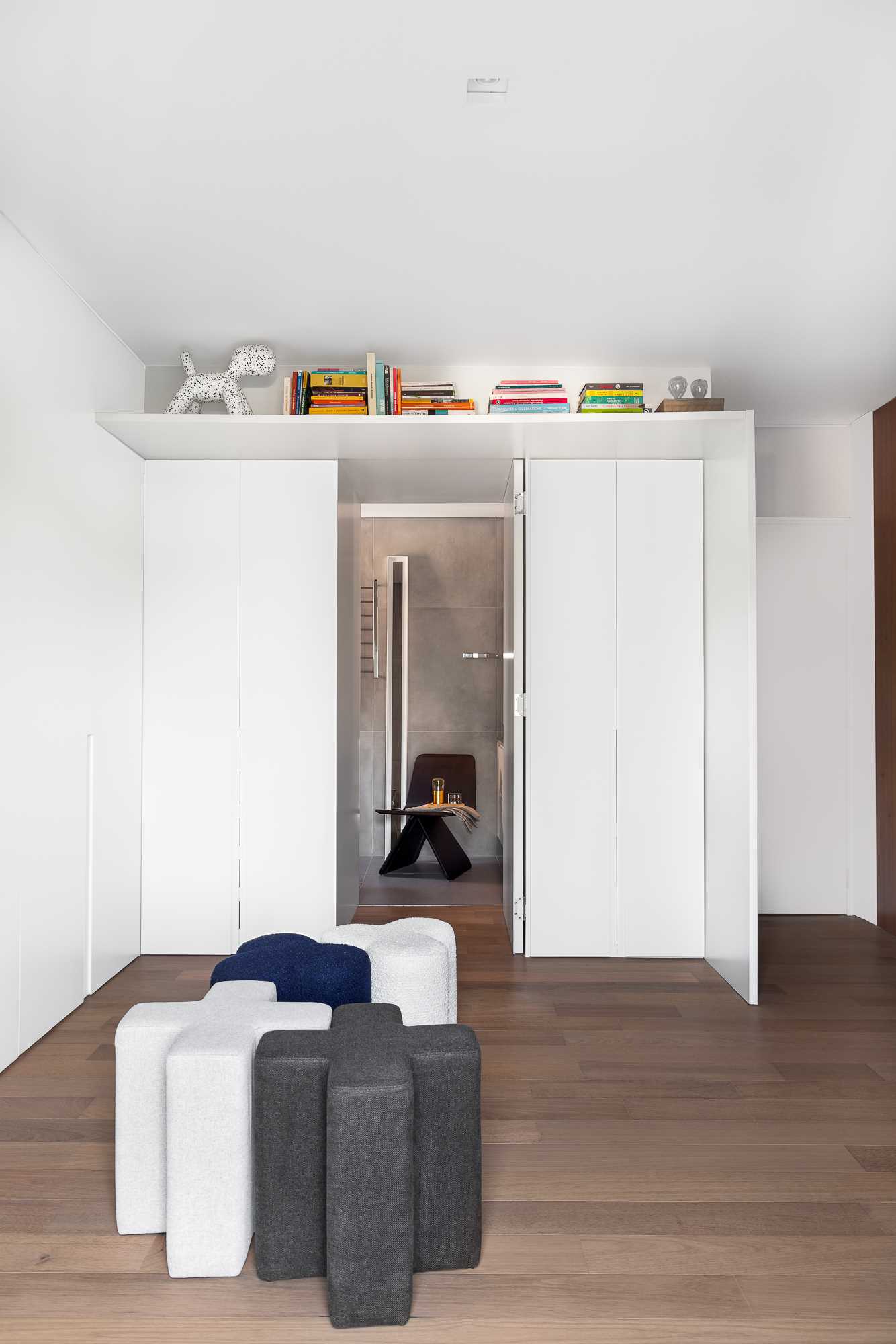 Cabinetry lines the wall and wraps around the door to the bathroom.