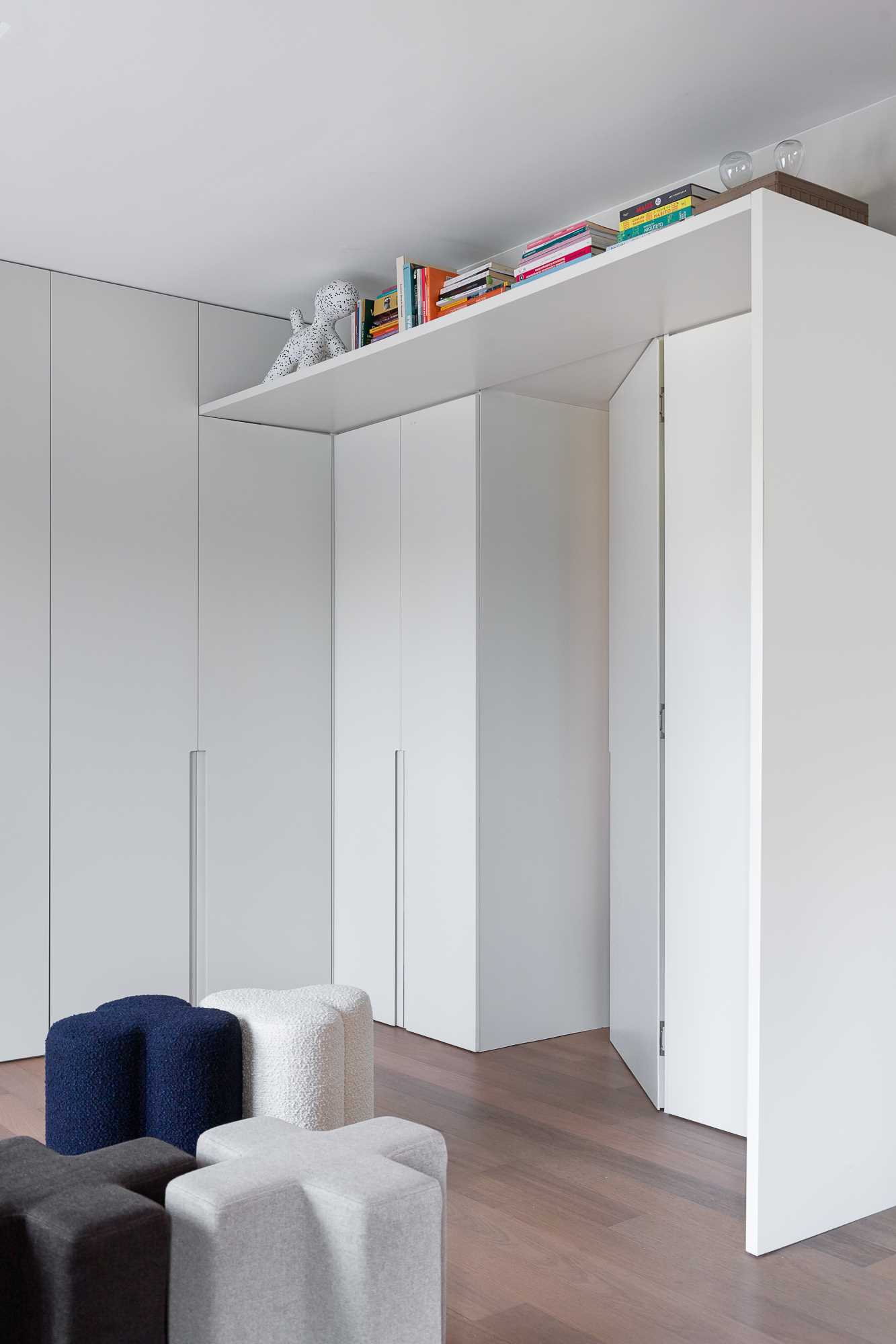 Cabinetry lines the wall and wraps around the door to the bathroom.