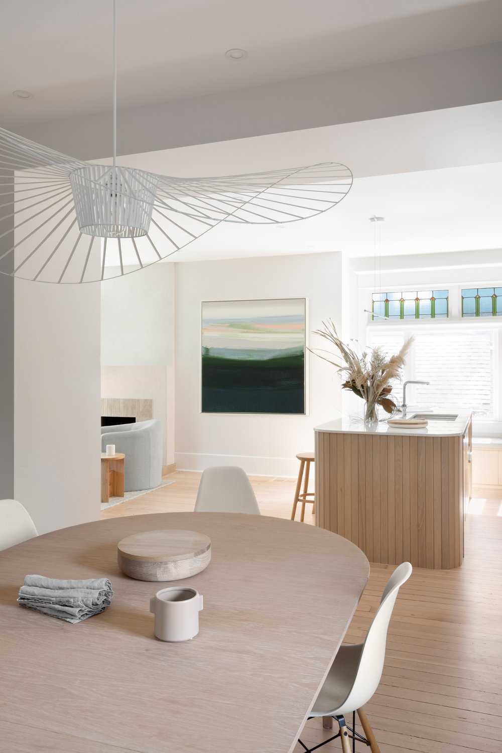 A modern coastal-inspired dining room with a neutral and contemporary color palette.