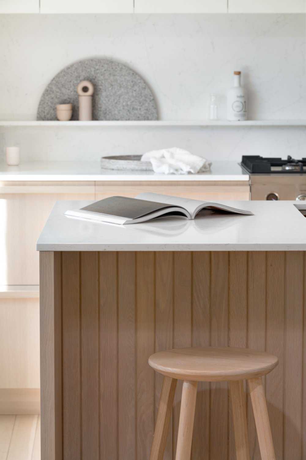 A modern coastal-inspired kitchen with a neutral and contemporary color palette.