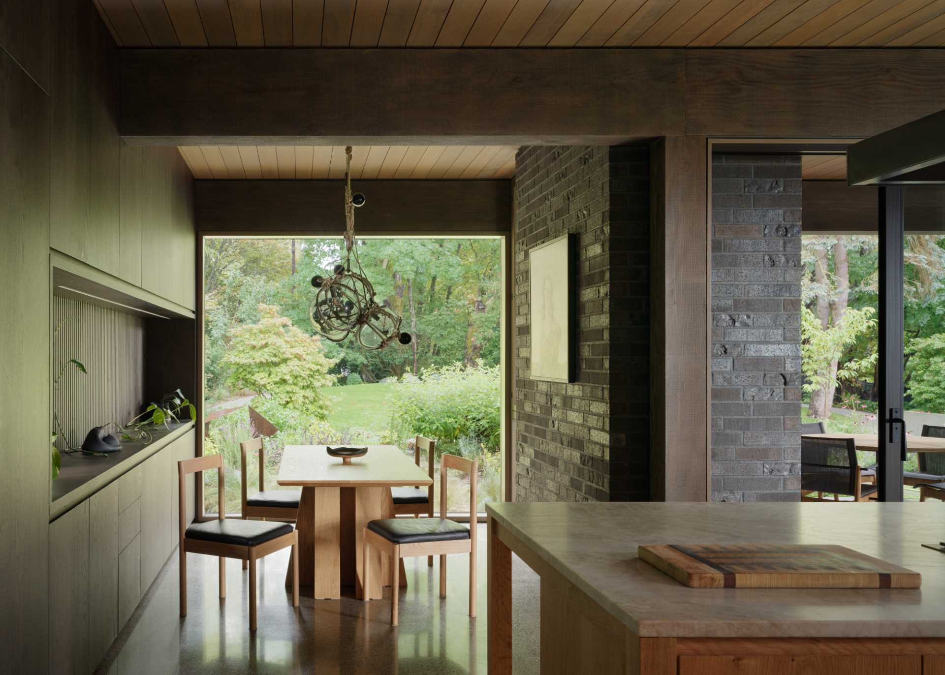 A contemporary breakfast nook with a large picture window and built-in storage.