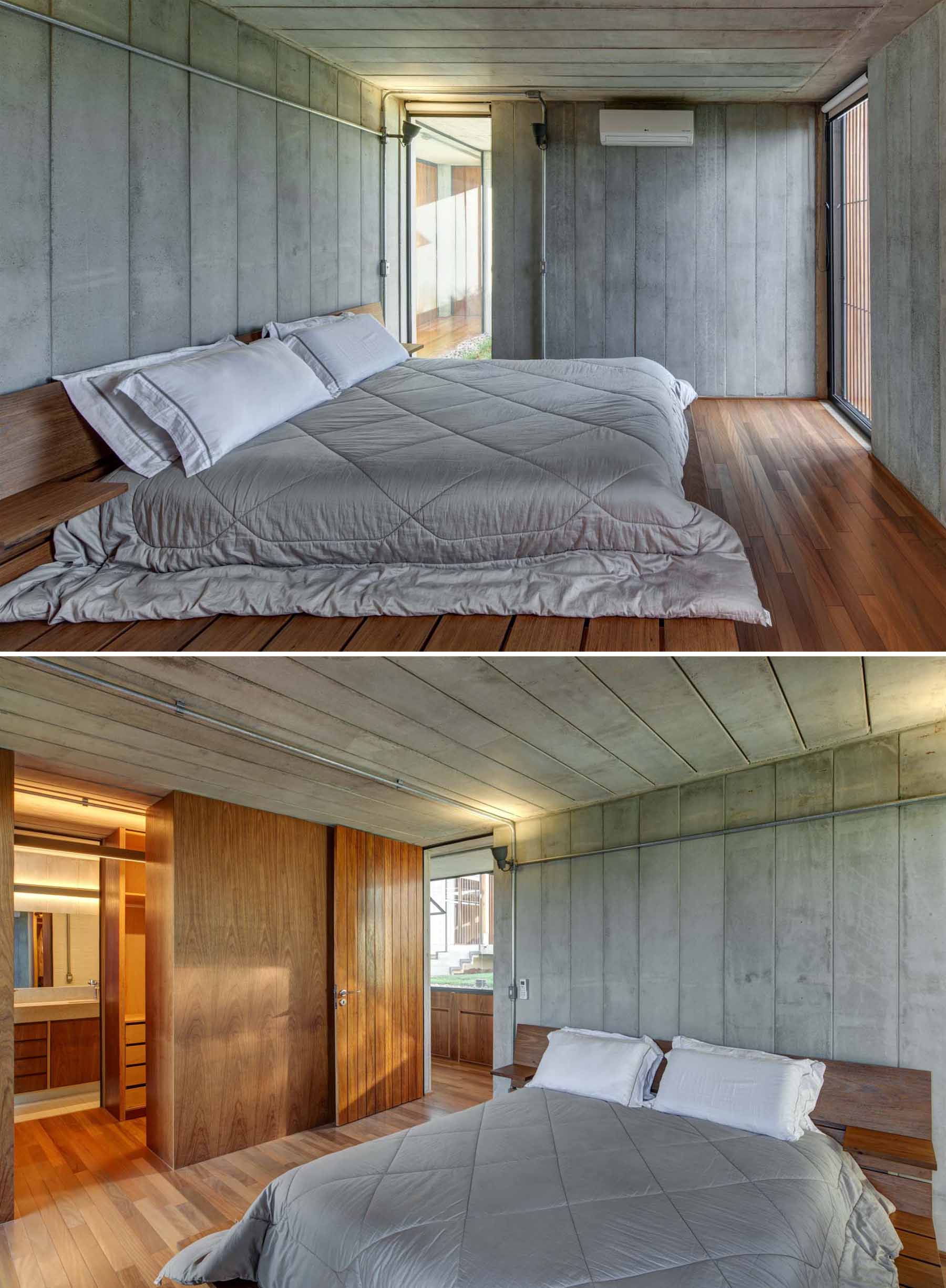 A modern bedroom combines concrete walls with wood floors, cabinetry and accents.