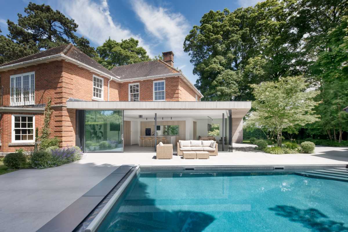 A new contemporary extension with sliding glass walls, makes room for an open plan kitchen and dining area.