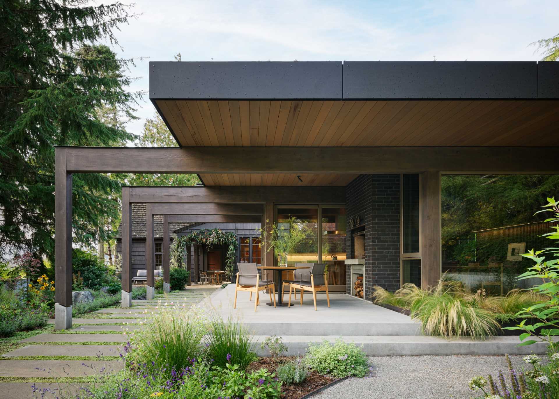 A contemporary extension was added to an old house, and includes a terrace, and new kitchen and dining area.