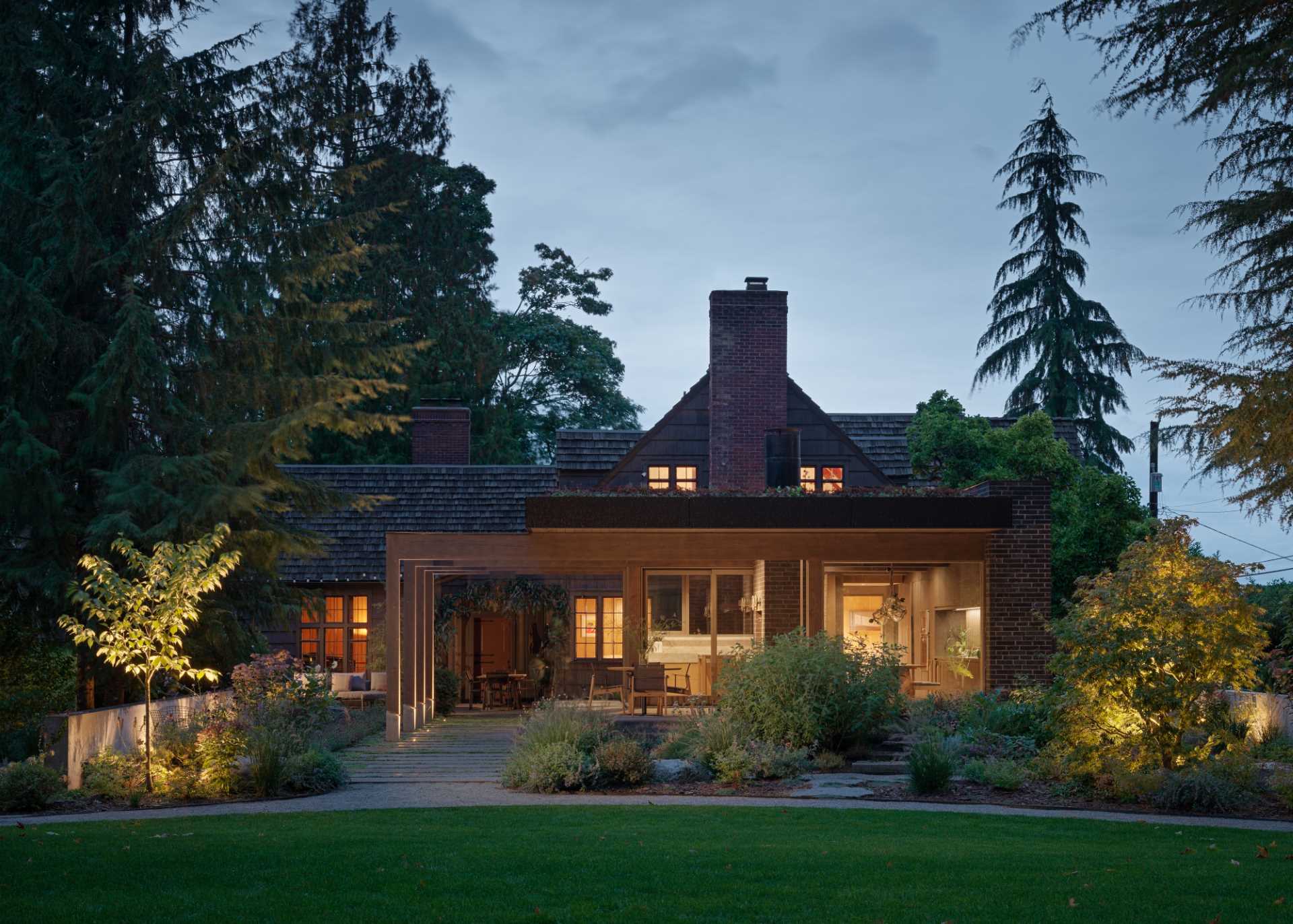 A contemporary extension was added to an old house, and includes a terrace, and new kitchen and dining area.