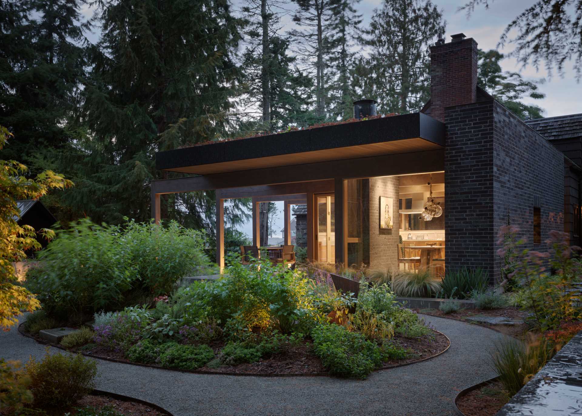 A contemporary extension was added to an old house, and includes a terrace, and new kitchen and dining area.