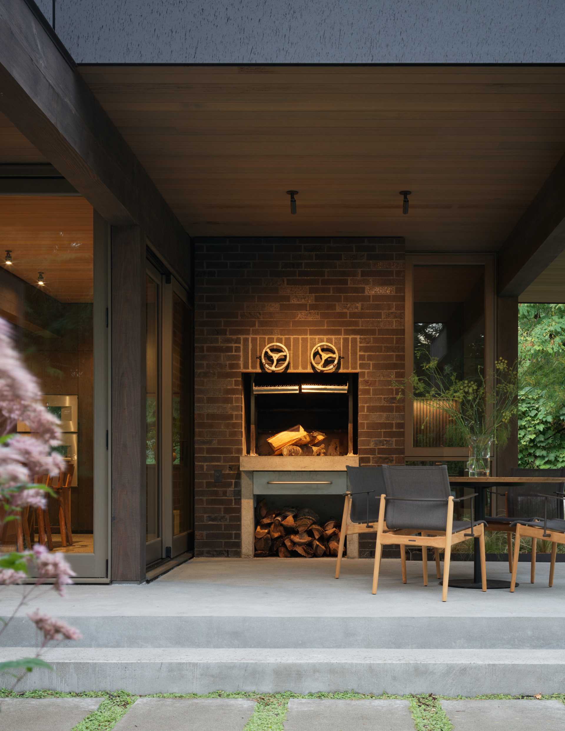 This terrace has a brick-enclosed wood-fired BBQ system, and the brick extends around to the street side of the addition to form a protective privacy wall.