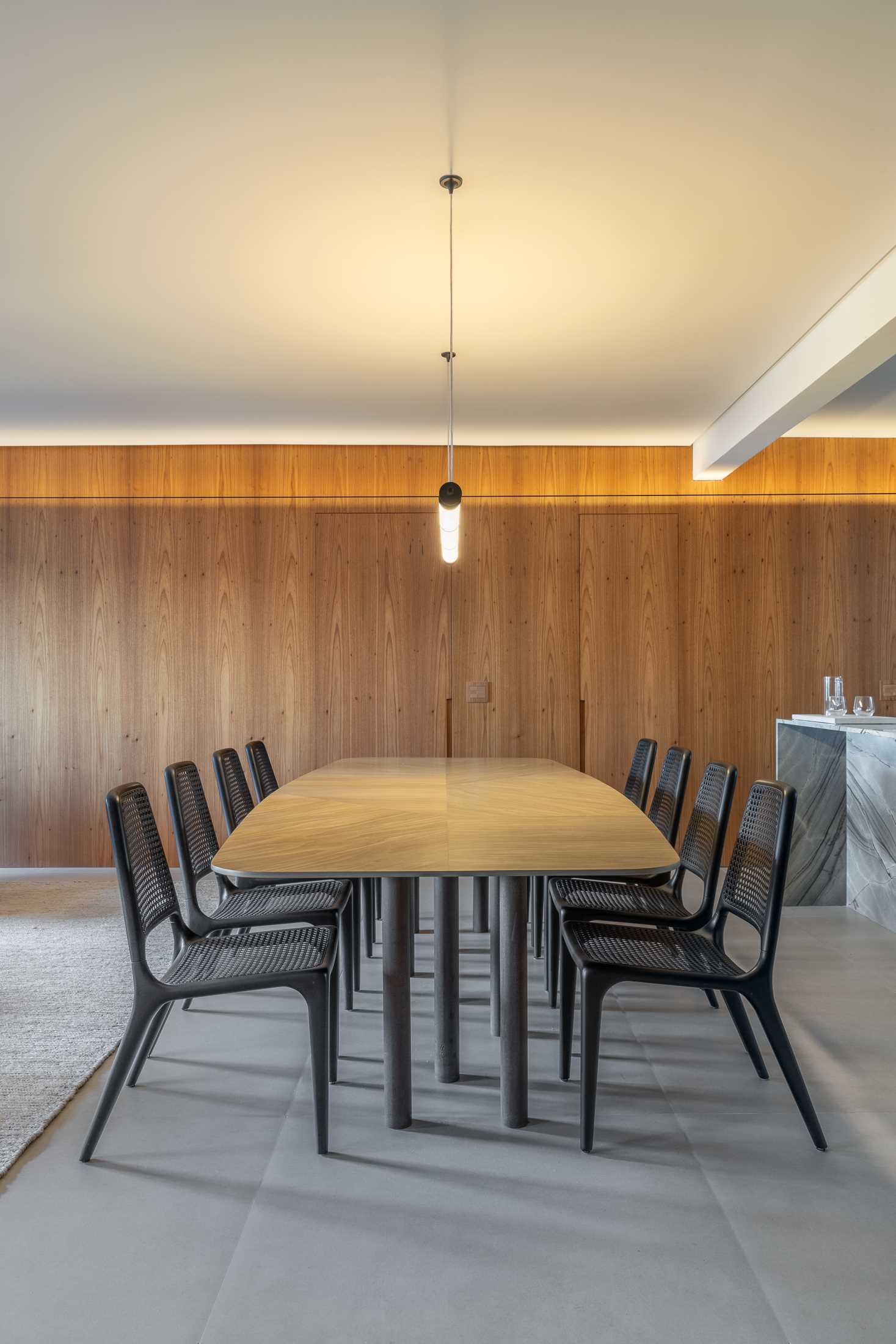 A modern open-plan dining area in a renovated apartment.