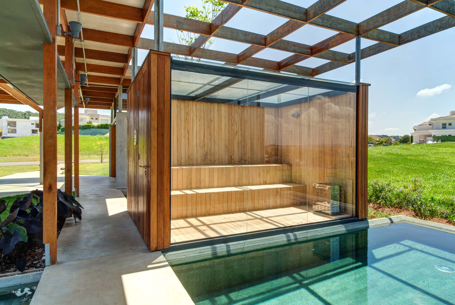 A glass-enclosed sauna at the end of the pool provides an additional place to relax.