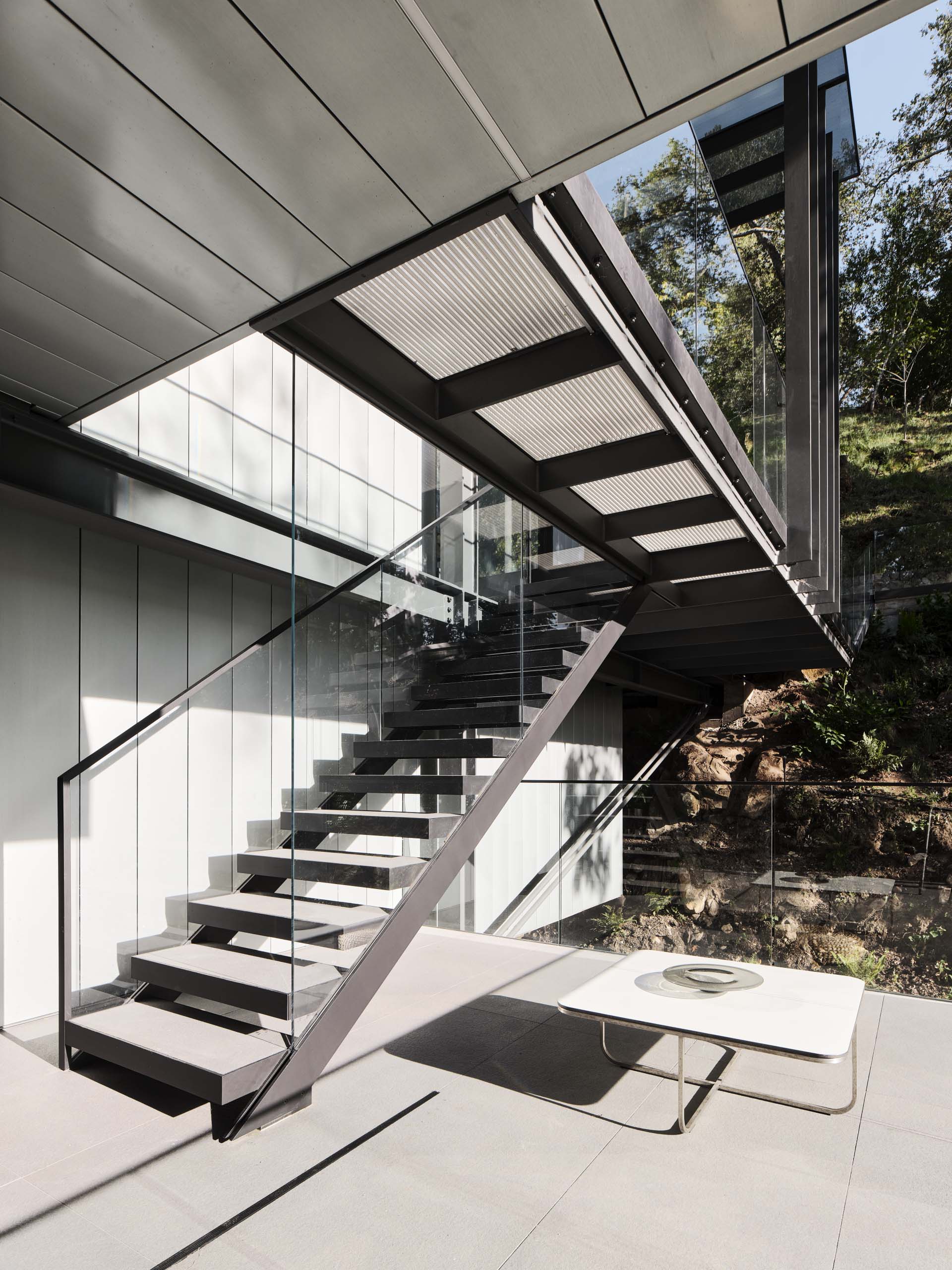 Exterior stairs connect the outdoor spaces of this modern home.